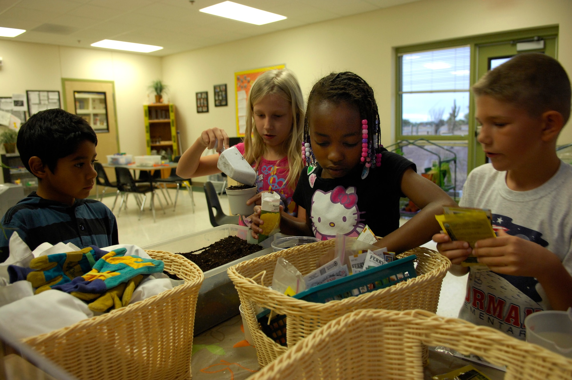 Children at the School Age Program plant seeds at the center at Davis-Monthan Air Force Base, Ariz., Nov. 22, 2013. The Desert Lightning 1st Six is planning to build a greenhouse for the science room that will teach kids the process of growing different types of seeds.(U.S. Air Force Photo by Airman 1st Class Betty R. Chevalier/Released)
