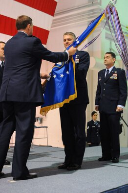 Col. Barry Gorter (center), incoming commander of the 123rd Airlift Wing, accepts the unit guidon from Maj. Gen. Edward Tonini, Kentucky’s adjutant general, during a change-of-command ceremony at the Kentucky Air National Guard Base in Louisville, Ky., Nov. 24, 2013, as Col. Warren Hurst (right), the outgoing wing commander, observes. Hurst has been named Kentucky’s assistant adjutant general for Air. (U.S. Air National Guard photo by Staff Sgt. Vicky Spesard)