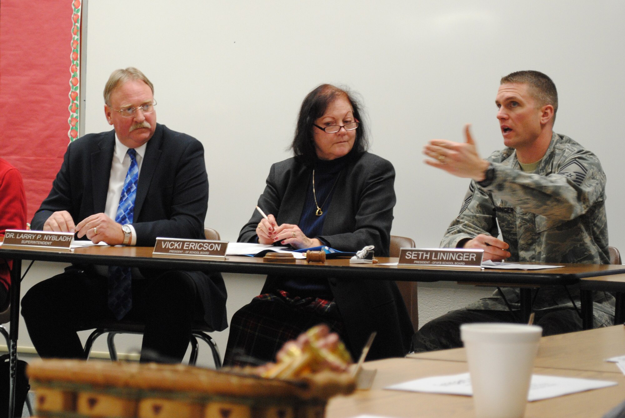 Grand Forks Air Force Base School Board president, Senior Master Sgt. Seth Lininger, addresses a question about the decision to keep the two public schools on base open during a meeting between the school boards of Grand Forks and Grand Forks AFB, held Nov. 25, 2013, at Nathan Twining Elementary School on Grand Forks AFB, N.D. The meeting between the two school boards is held annually and allows board members, school administrators and community residents to address various topics in person. (U.S. Air Force photo/Staff Sgt. Luis Loza Gutierrez) 
