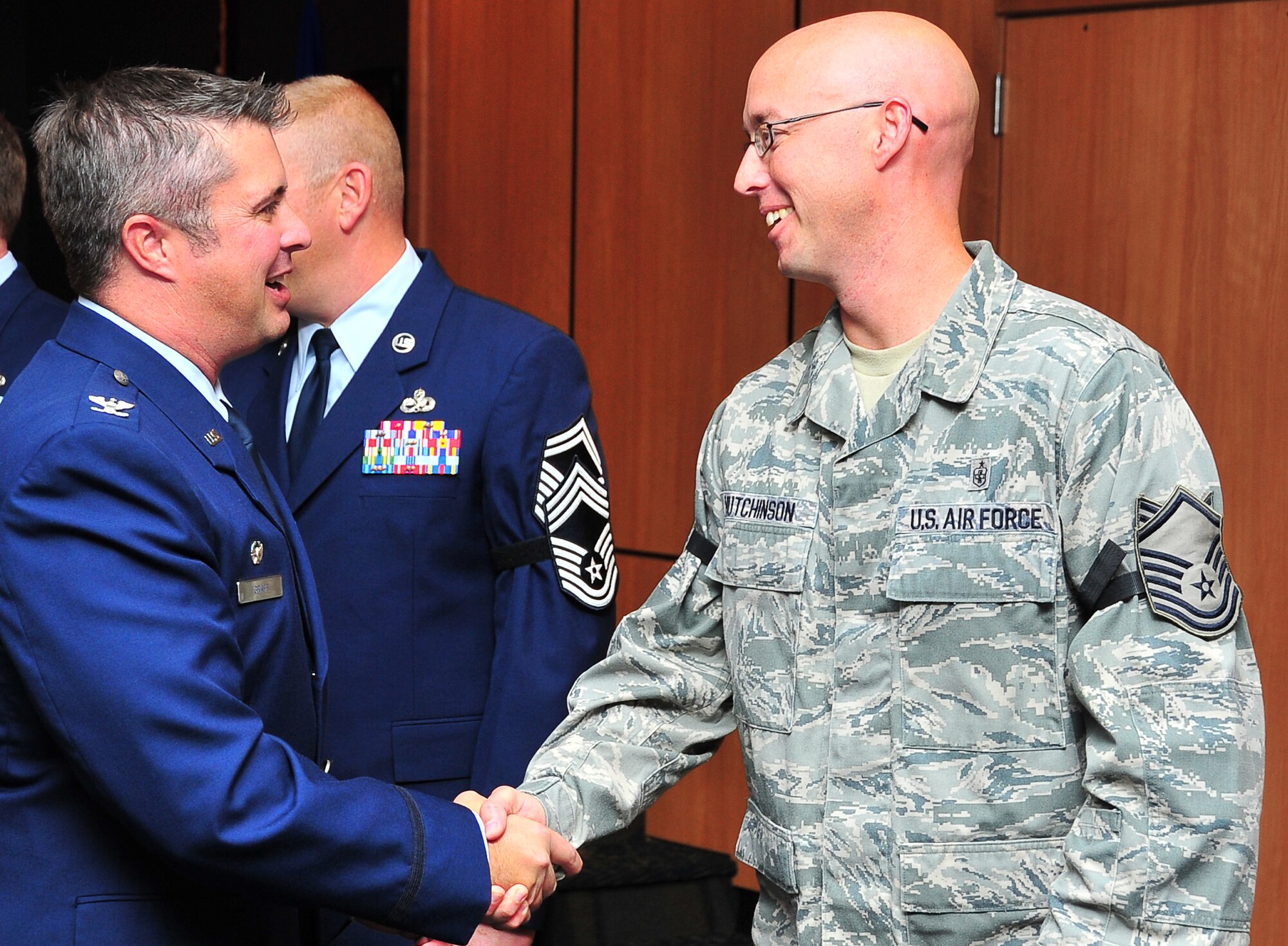 Col. David. E. Graff, 325th Fighter Wing commander, shakes the hand of Master Sergeant Craig Hutchinson, 325th Medical Operations Squadron Maternal Child Flight Chief, Nov. 26 at Horizons Community Center. Hutchinson was selected for Stripes for Exceptional Performers promotion from technical sergeant to master sergeant. (U.S. Air Force photo by Airman 1st Class Sergio Gamboa)