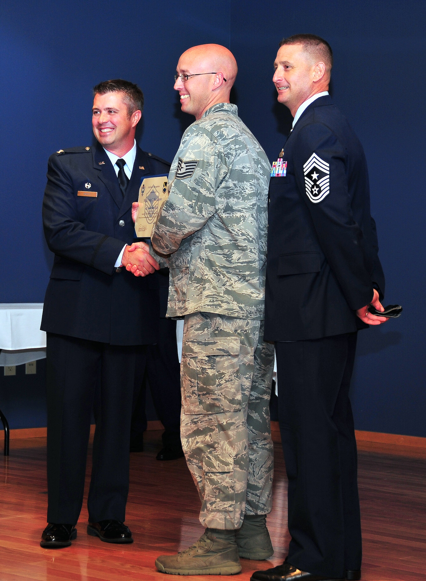 Col. David. E. Graff, 325th Fighter Wing commander, and Chief Master Sgt. Ray DeVite, 325th Fighter Wing command chief, award Master Sergeant Craig Hutchinson, 325th Medical Operations Squadron Maternal Child Flight Chief, with a Stripes for Exceptional Performers promotion from technical sergeant to master sergeant Nov. 26 at the Horizons Community Center. (U.S. Air Force photo by Airman 1st Class Sergio Gamboa)