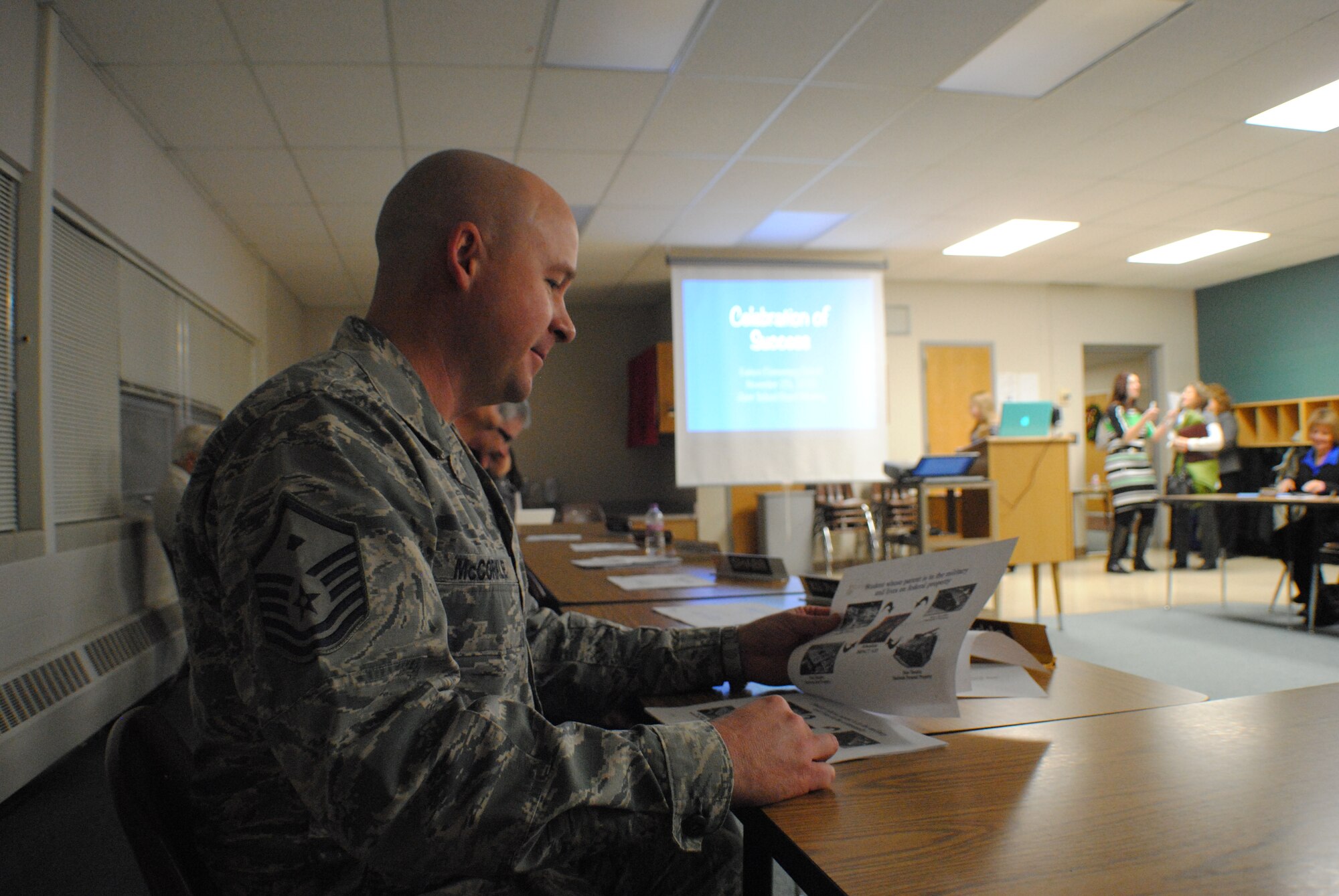 Master Sgt. Richard McCorkel, Grand Forks Air Force Base School Board member, reads  an overview on Impact Aid provided by the superintendent of Grand Forks Public Schools, Dr. Larry P. Nybladh, in preparation for a special presentation during an annual joint meeting between the school boards of Grand Forks and Grand Forks Air Force Base, held Nov. 25, 2013, at Nathan Twining Elementary School on Grand Forks AFB, N.D. Impact Aid is an in-lieu-of-tax federal program administered by the U.S. Department of Education. (U.S. Air Force photo/Staff Sgt. Luis Loza Gutierrez) 