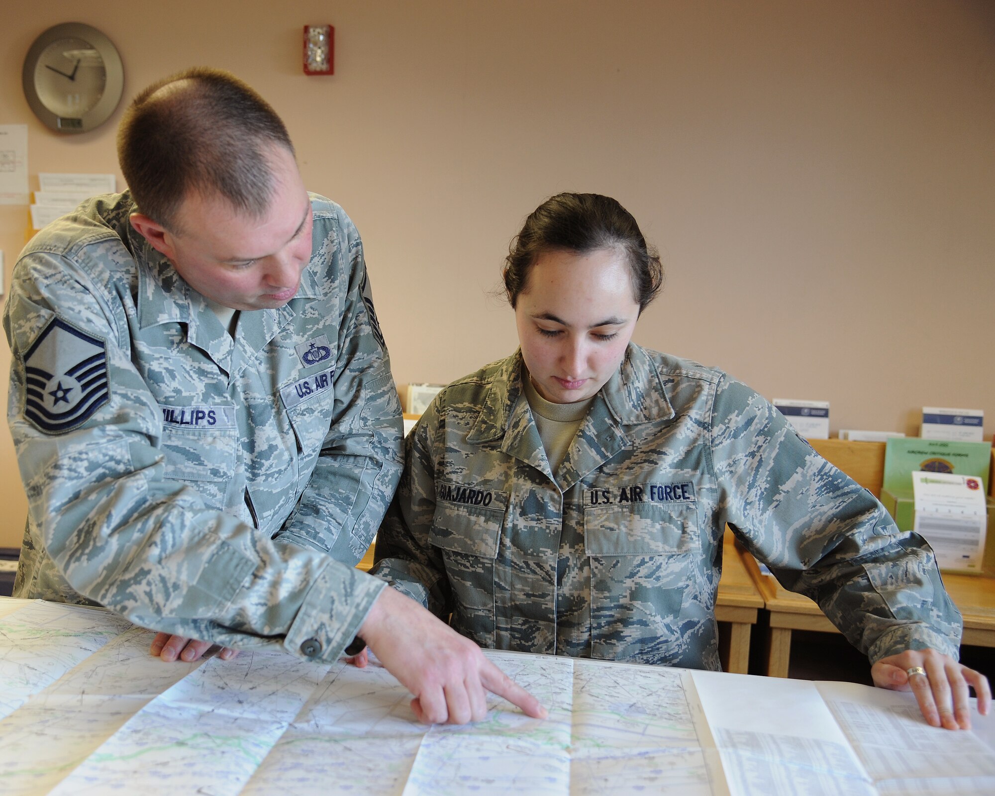 Senior Airman Sara Guajardo, 319th Operations Support Squadron airfield management shift lead, and Master Sgt. Jay Phillips, 319th OSS deputy air field manager practice following flight plans of various aircraft, Nov. 26, 2013, on Grand Forks Air Force Base, N.D.   The Austin, Texas, native is the 319th Air Base Wing’s Warrior of the Week for the last week of November 2013. (U.S. Air Force photo/Airman 1st Class Zachiah Roberson)