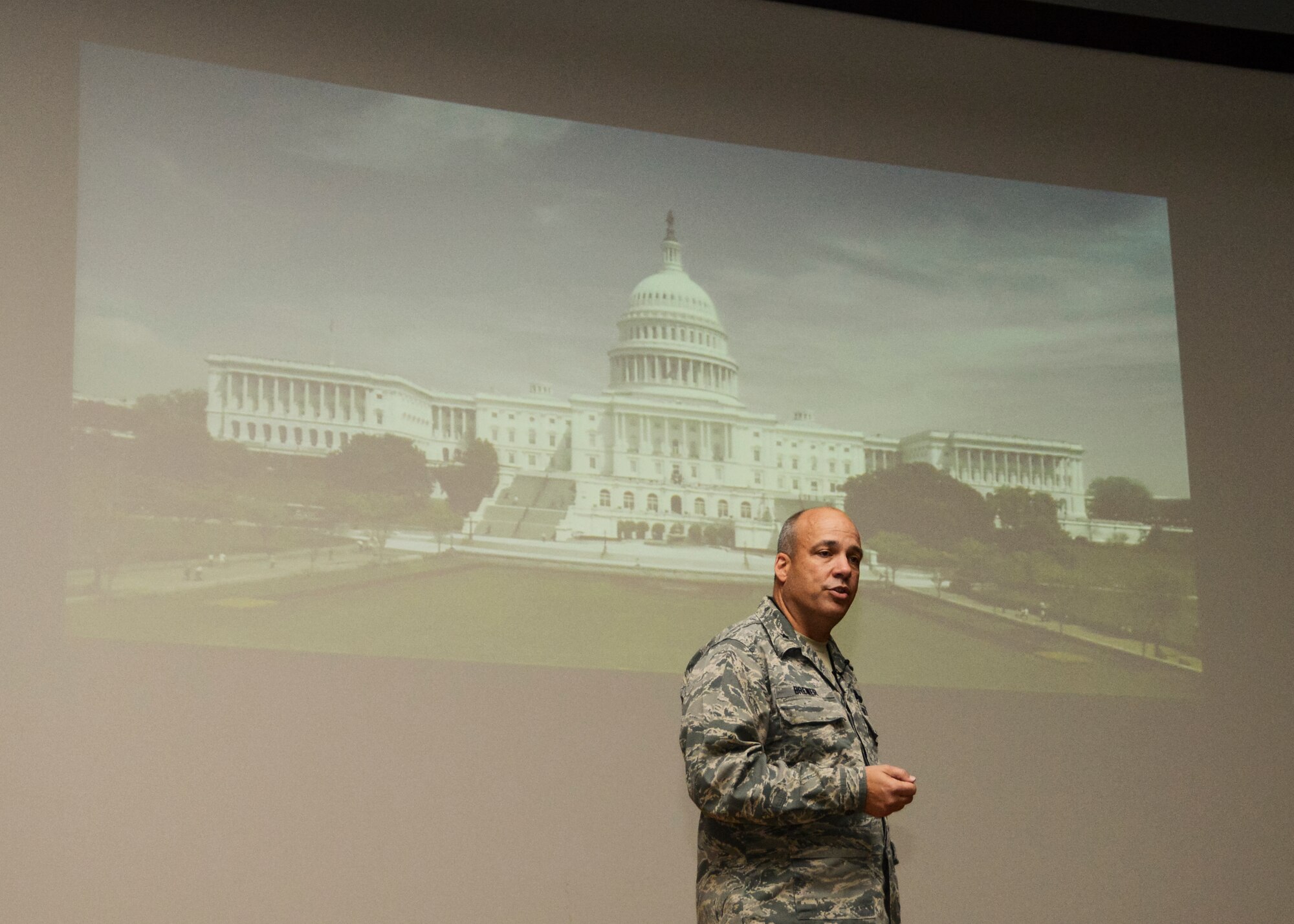 Brig. Gen. Michael T. Brewer, 412th Test Wing commander, asks members of the audience at the Base Theater to send him personal impact stories about recent budget cuts as he prepares for his trip to Capitol Hill Dec. 9. Brewer held four commander's calls Nov. 26 to address and update Team Edwards on various issues affecting the base. (U.S. Air Force photo by Rebecca Amber)
