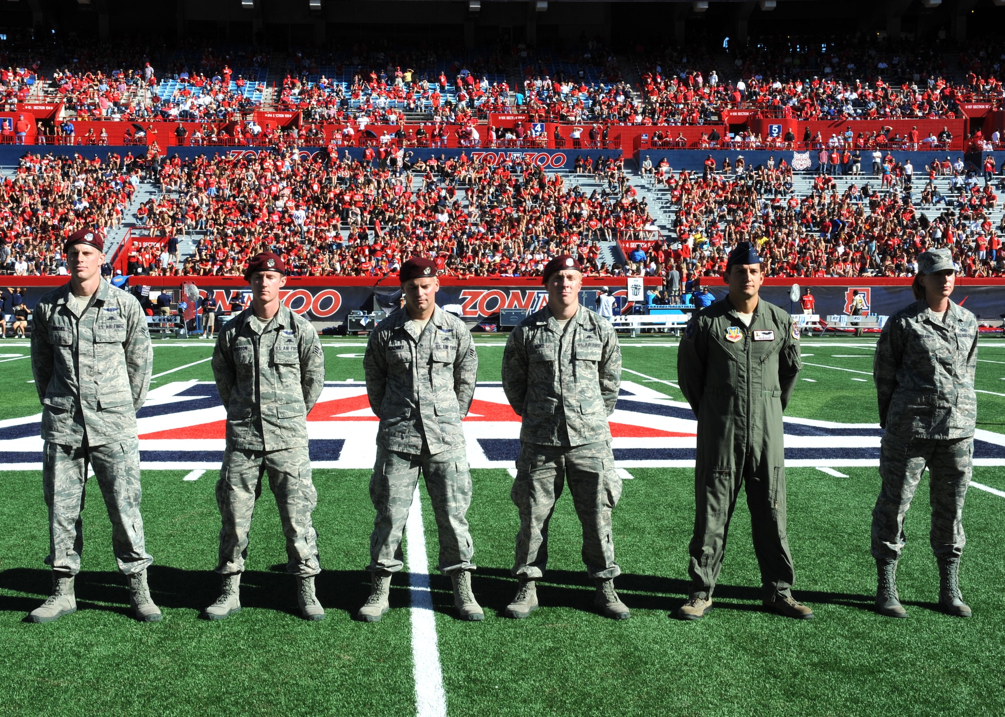 U.S. Air Force members stand on the field during a ?Welcome Home Heroes? ceremony during halftime of a University of Arizona football game at Arizona Stadium, Tucson, Ariz., Nov. 16, 2013.  The ceremony recognized military members who have recently returned home from deployments. (U.S. Air Force photo by Airman 1st Class Chris Massey/Released)