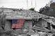 A United States flag hangs from a home devastated by a tornado that hit the town of Moore, Okla. May 20, 2013 near Tinker Air Force Base. (U.S. Air Force photo illustration by Maj. Jon Quinlan)