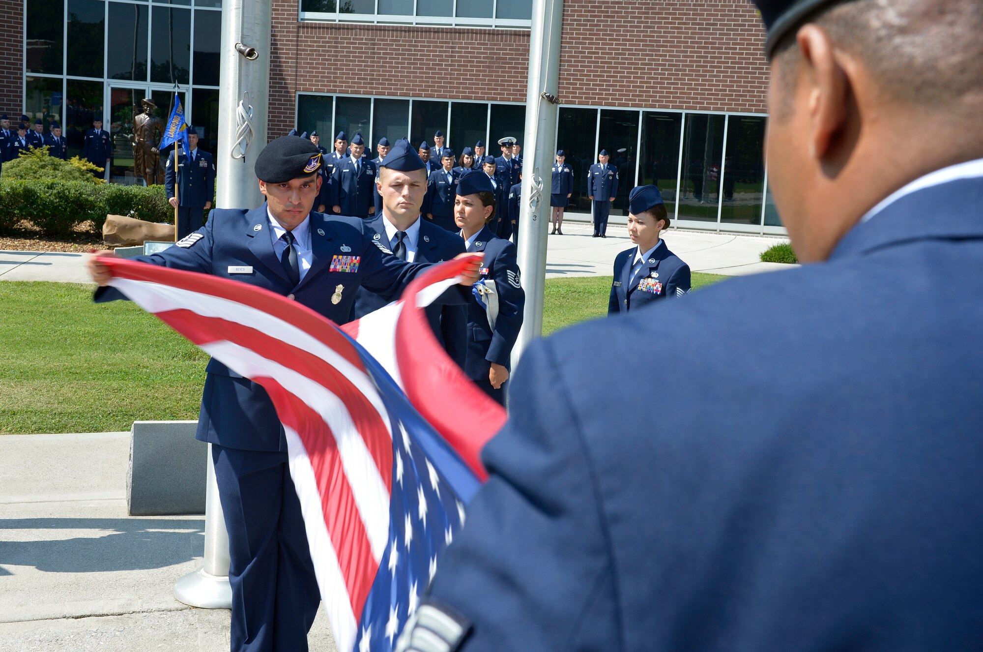 MCGHEE TYSON AIR NATIONAL GUARD BASE, Tenn. - Tech. Sgt. Jorge Reyes, from Scott AFB, starts a tabletop prior to folding the American flag during a post-graduation retreat ceremony at the I.G. Brown Training and Education Center, Aug 15, 2013. Three hundred thirty-six students in the Noncommissioned Officer Academy Class 13-7 and Airmen Leadership School Class 13-6 graduated . (U.S. Air National Guard photo by Master Sgt. Kurt Skoglund/Released)