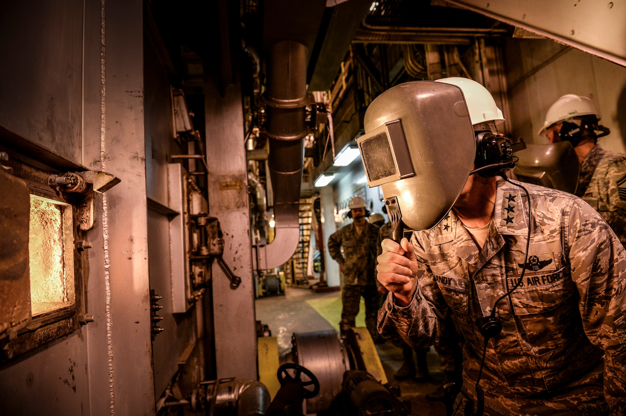 U.S. Air Force Lt. Gen. Russell Handy, 11th Air Force commander, looks into a coal furnace at the Central Heat and Power Plant, Nov. 21, 2013, Eielson Air Force Base, Alaska. Handy received a detailed tour of the power plant to better understand Eielson's unique operations.  (U.S. Air Force photo by Airman 1st Class Peter Reft/Released)
