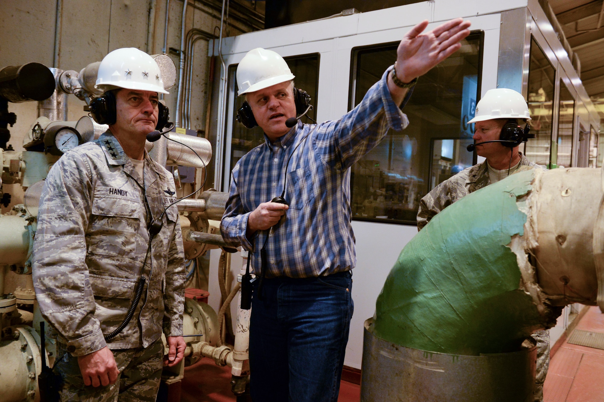 U.S. Air Force Lt. Gen. Russell Handy, 11th Air Force commander, Brig. Gen. Mark Kelly, 354th Fighter Wing commander, and Marty Overlin, 354th Civil Engineer Squadron central heat and power plant superintendent, examine turbines at the Central Heat and Power Plant Nov. 21, 2013, Eielson Air Force Base, Alaska. Handy stopped at Eielson to visit the Airmen and familiarize themselves with Eielson's unique operations.  (U.S. Air Force photo by Airman 1st Class Peter Reft/Released)