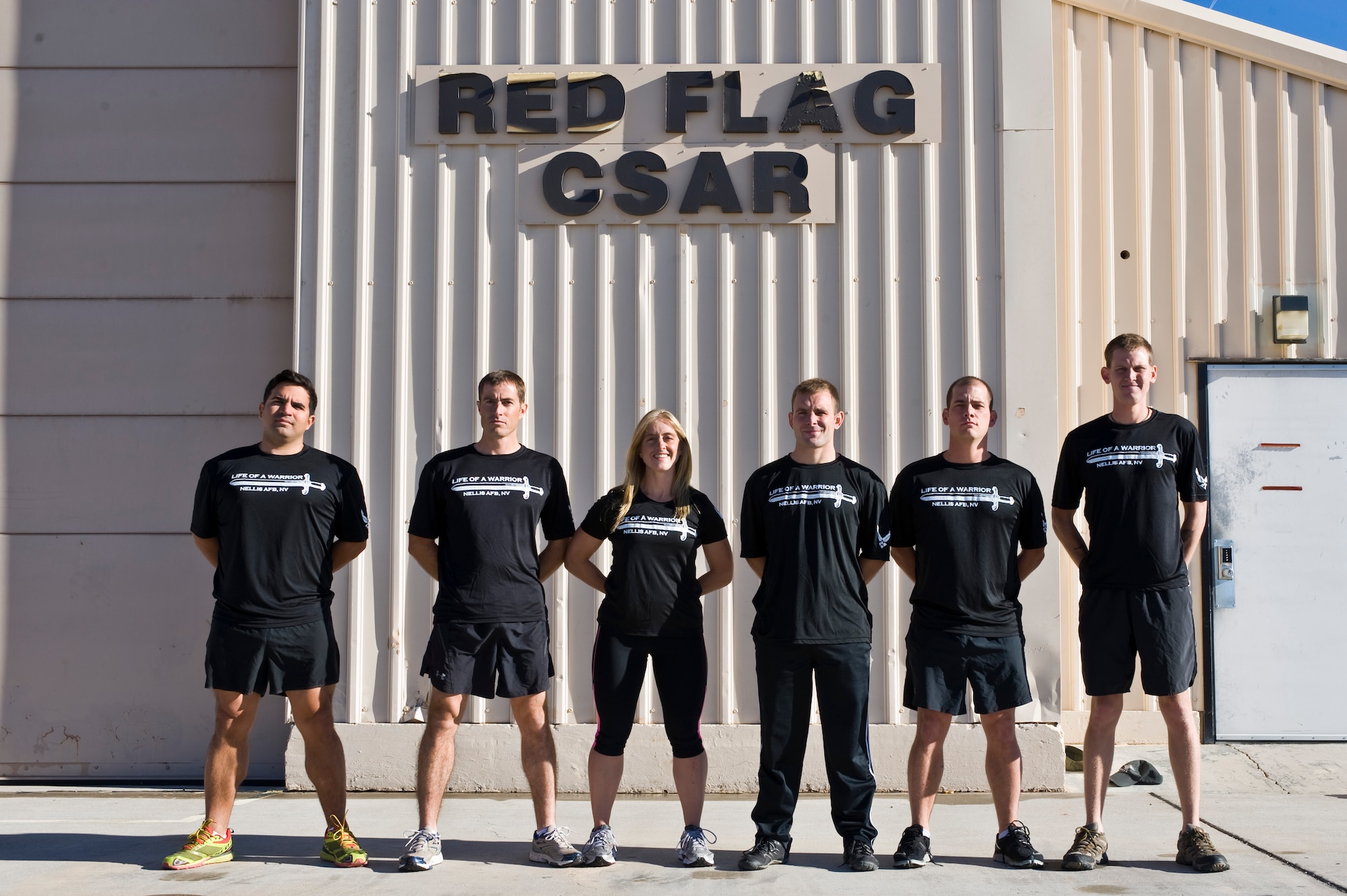 U.S. Air Force Staff Sgt. Paul Merck, 414th Combat Training Squadron survival, evasion, resistance and escape specialist, Tech. Sgt. Ryan Wilkerson, 414th CTS SERE specialist, Tiffany Wilkerson, Las Vegas Athletic Club group fitness instructor, Staff Sgt. Robert Miner, 414th CTS SERE specialist, Staff Sgt. Derek Owens, 414th CTS SERE specialist, and Staff Sgt. Matthew Greer, 414th CTS SERE specialist, pose for a group photo outside of building 226 Nov. 25, 2013, at Nellis Air Force Base, Nev. This six person team finished the 187 miles of the Ragnar Relay Las Vegas Nov. 8 through Nov. 9, finishing in 24 hours and 18 minutes. The team placed eleventh overall and first place in the six person Ultra teams. (U.S. Air Force photo by Airman 1st Class Christopher Tam)