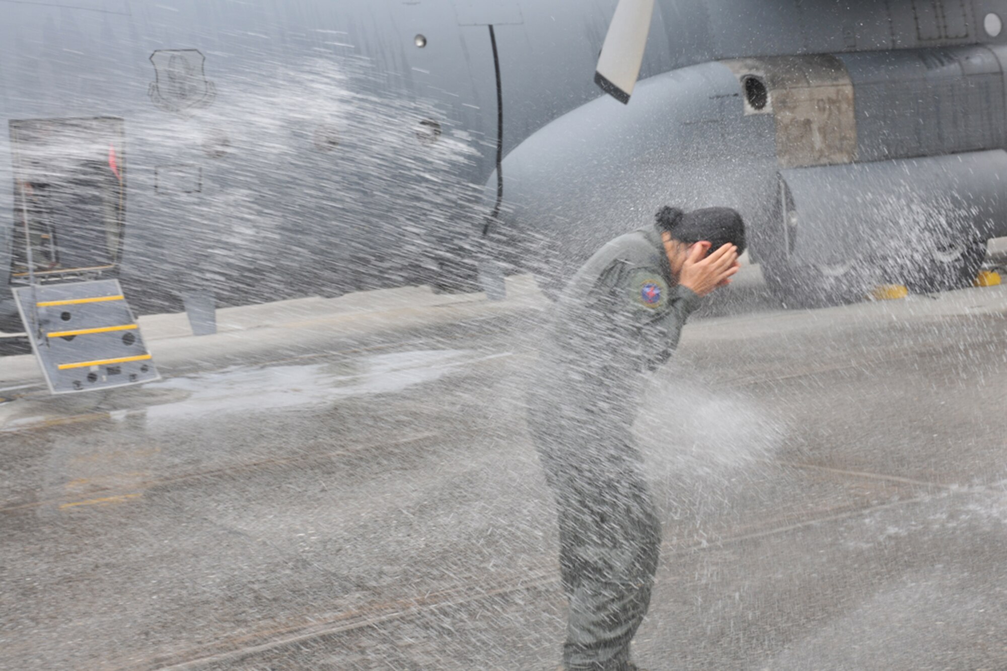 Lt. Col. Cynthia Bradford, 94th Aeromedical Evacuation Squadron chief flight nurse, receives the traditional wash down following her final C-130 flight Oct. 27 after 25 years of military service. (U.S. Air Force photo/Senior Airman Elizabeth Van Patten)