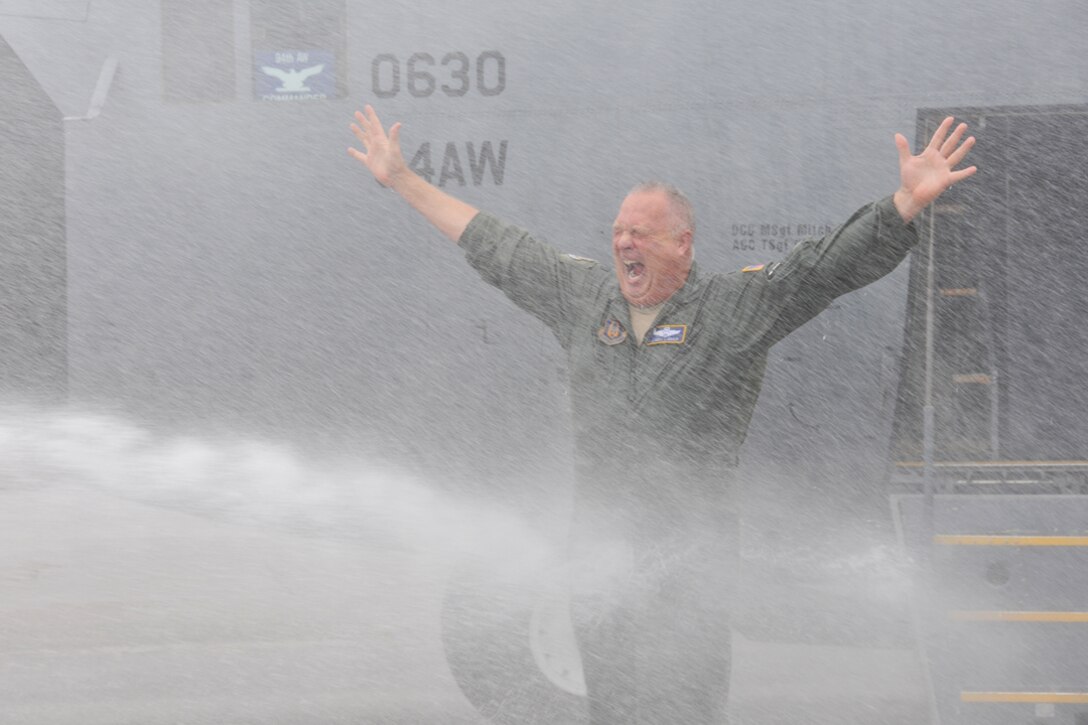 Airmen soak Col. James Linder, 22nd Air Force director of operations, after his final C-130 flight Oct. 27. (U.S. Air Force photo/Senior Airman Elizabeth Van Patten)