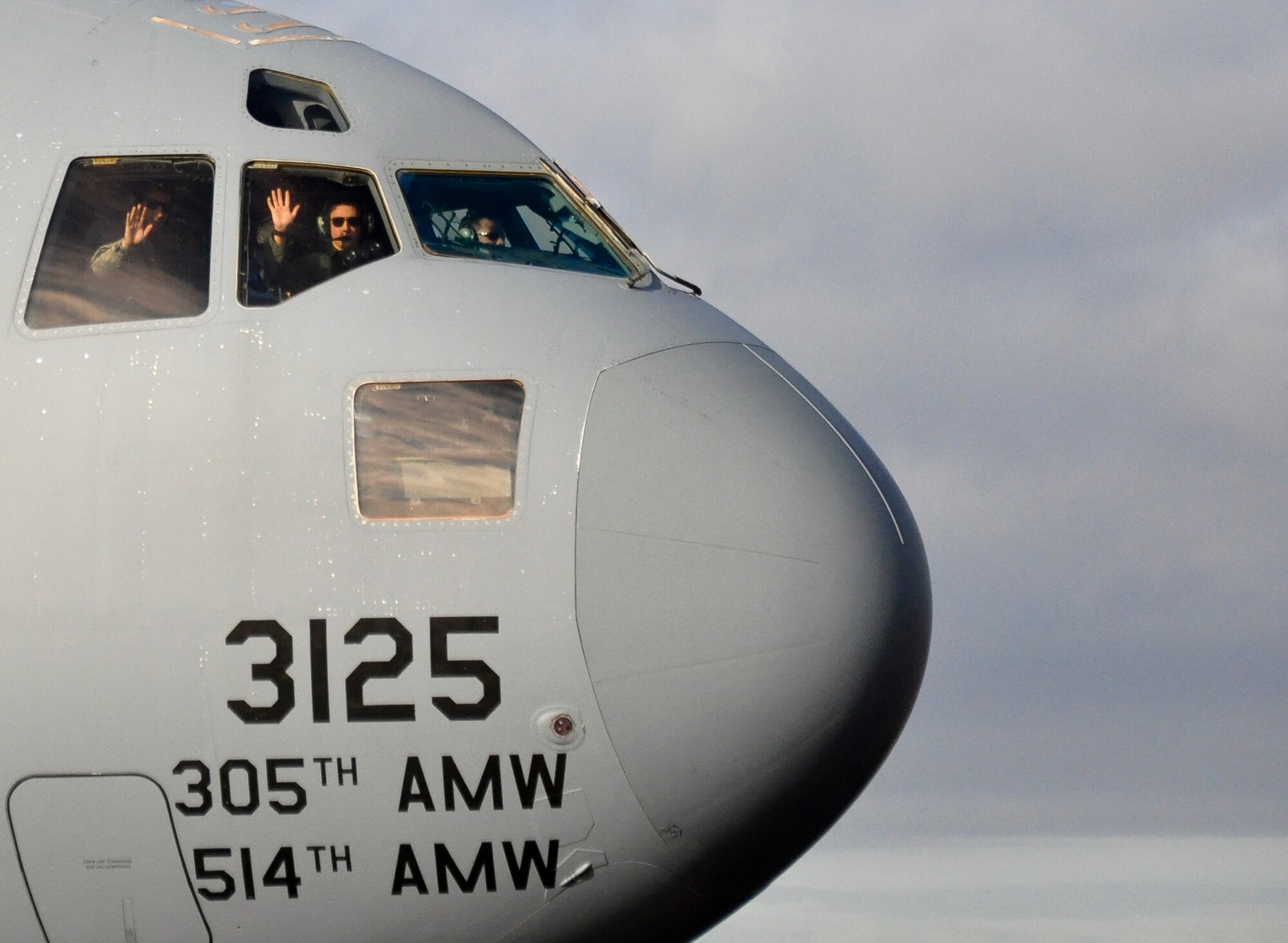 From left to right, Senior Airman Nikolaus Klenovits, 6th Airlift Squadron Aviation Resource Management specialist; 1st Lt. Lindsay Harte, C-17 Globemaster III copilot, and Maj. Clinton Palmer, C-17 aircraft commander, watch aircraft take off during the 'Elephant Walk' Nov. 21, 2013, at Joint Base McGuire-Dix-Lakehurst, N.J. The formation, affectionately known as an “Elephant Walk” was part of a training exercise involving 12 KC-10 Extenders and six C-17s from the 305th Air Mobility Wing. (U.S. Air Force photo by 2nd Lt. Carrie Volpe/Released)