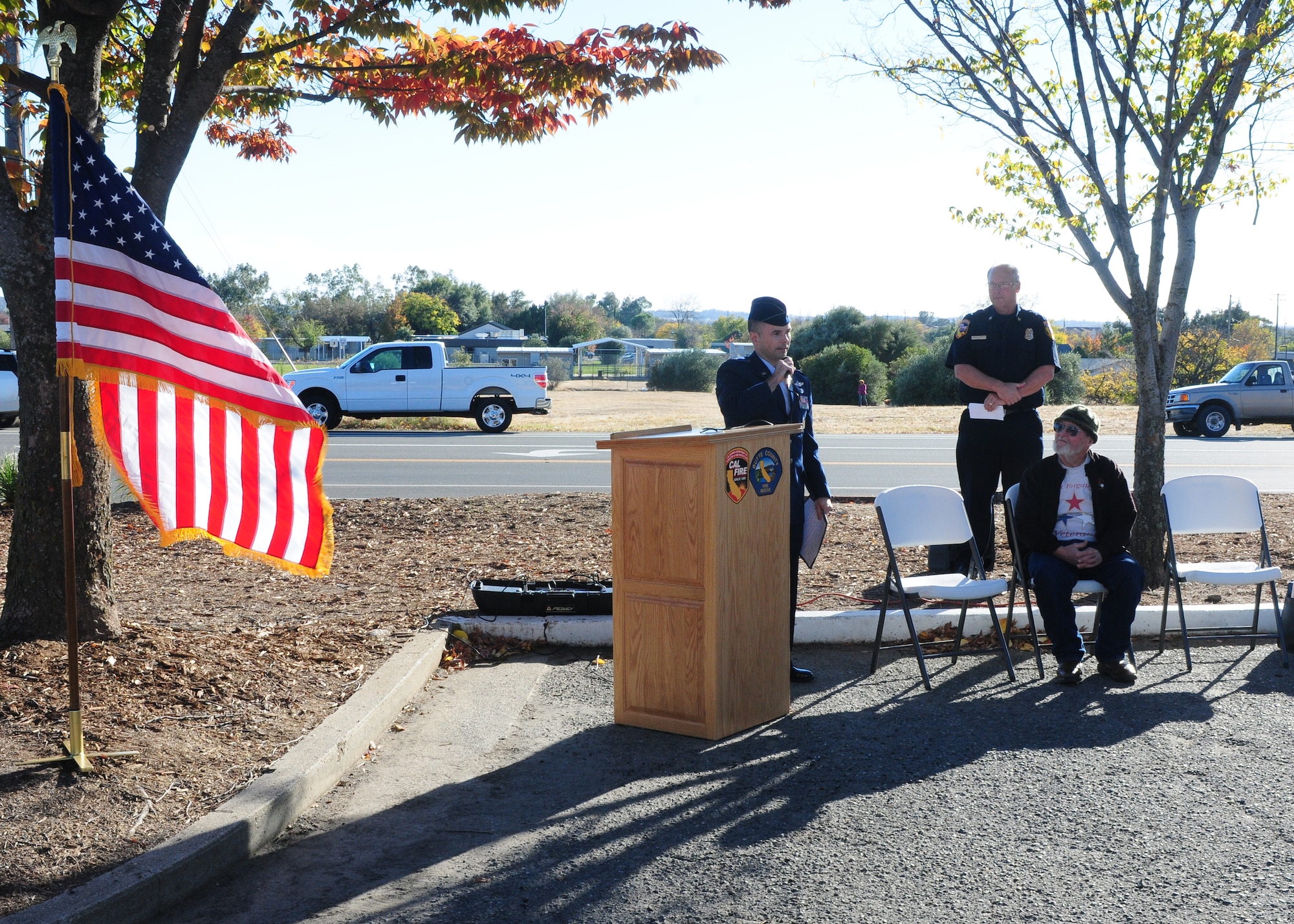 Lt. Col. Colby Kuhns, 1st Reconnaissance Squadron commander, speaks to residents of Oroville, during a memorial honoring Capt. Randy Roby and Ms. Geraldine Vering at the Cal-Fire Butte County Headquarters in Oroville, Calif., Nov. 22, 2013. Cal-Fire Butte County replaced a wooden memorial with a new metal and stone monument. (U.S. Air Force photo by Senior Airman Allen Pollard/Released)