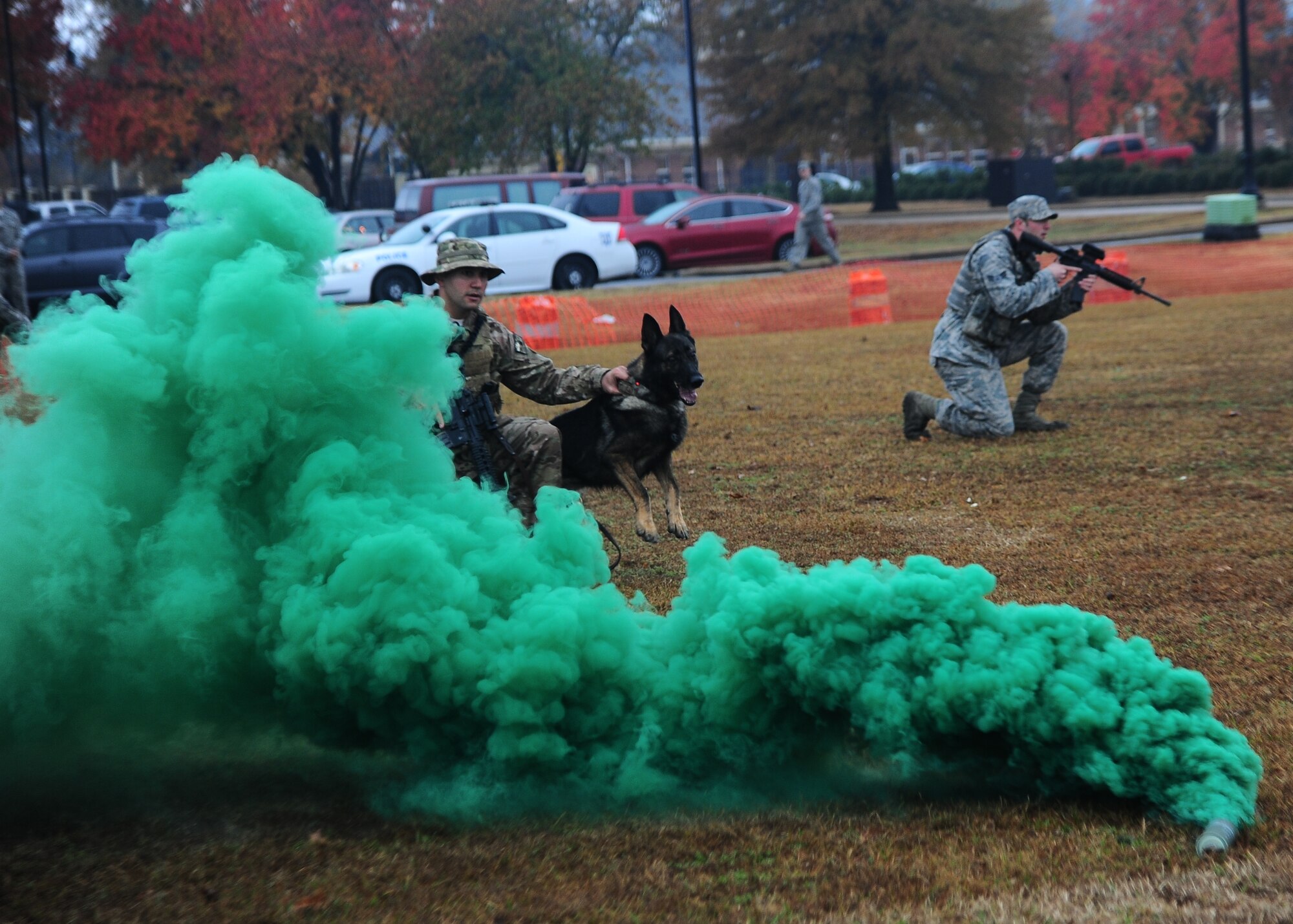 Staff Sgt. David MacDonald, 14th Security Forces Squadron, holds back Ali, a military working dog, before allowing him to rush through a window after a criminal during the Military Working Dog Demonstration Nov. 22 outside of the Columbus Club. (U.S. Air Force Photo/Airman 1st Class Daniel Lile)