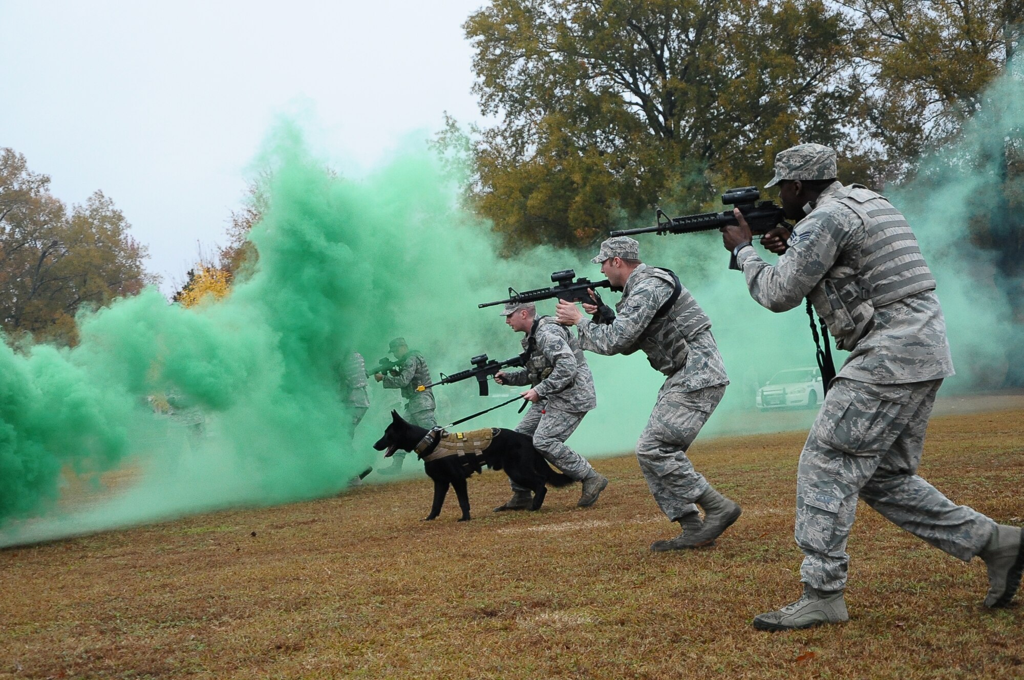 Members of the 14th Security Forces Squadron perform a tactical movement with the help of military working dog, Maci, at the Military Working Dog Demonstration Nov. 22 outside of the Columbus Club. (U.S. Air Force Photo/Senior Airman Kaleb Snay)
