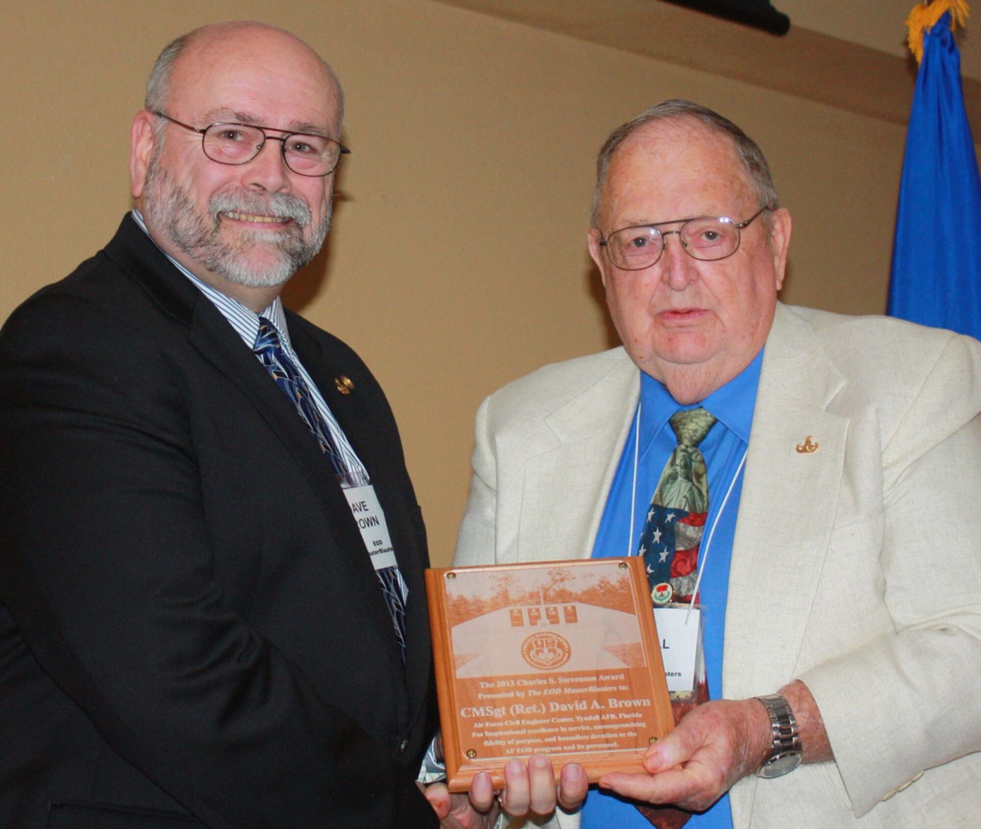 TYNDALL AIR FORCE BASE, Fla. - From left, David Brown receives the Charles S. Stevenson Lifetime Achievment award from Irv DuVall, president of the EOD Masterblasters during a ceremony Nov. 9, 2013. Throughout his active-duty career, Brown, a retired chief master sergeant, held positions at all levels of command including as the explosive ordnance disposal enlisted career field manager. He is currently the Air Force’s EOD subject matter expert at the Air Force Civil Engineer Center's Tyndall Detachment. (U.S. Air Force photo /Marshall Dutton)