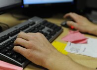 Jon Placak, 5th Force Support Squadron education specialist, enters financial aid information into his computer at Minot Air Force Base, N.D., Nov. 13. Placak works in the base education office and advises Airmen on financial aid and courses needed to obtain their Community College of the Air Force degree. (U.S. Air Force photo/Senior Airman Stephanie Sauberan)