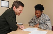 Jon Placak, 5th Force Support Squadron education specialist discusses financial aid with Staff Sgt. Latoya Gantt, 5th FSS noncommissioned officer in charge of formal training, at Minot Air Force Base, N.D., Nov. 13. Gantt is currently pursuing a degree in marketing and management. (U.S. Air Force photo/Senior Airman Stephanie Sauberan)