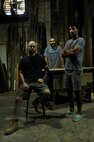 Peter Martin (left), James Klausmeyer (center), and James Battaglia (right), Sandtown Millworks employees, pose for a portrait at Sandtown Millworks in Baltimore, Md., Aug. 16, 2013.  Martin, Klausmeyer, and Battaglia made many pieces of furniture from reclaimed wood together in the warehouse. (U.S. Air Force photo by Tech. Sgt. Jasmin Taylor)