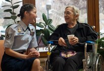 Staff Sgt. Kimura Helwig, 791st Missile Security Forces Squadron defender, spends time with a resident of Trinity Homes Retirement Community in downtown Minot Nov. 16, 2013. Helwig is a member of Friends of Veterans volunteer group, an organization that hosts various events for veterans throughout the year. (U.S. Air Force photo/Airman 1st Class Apryl Hall)