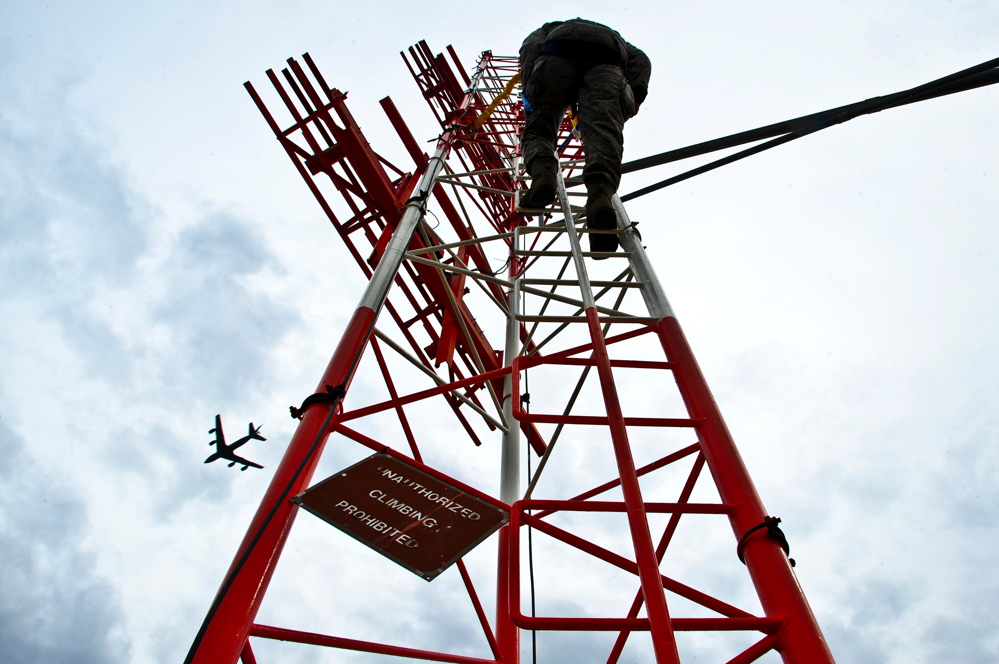 Senior Airman Darrian Gordon, 6th Communications Squadron airfield systems technician, climbs a glide slope antenna at MacDill Air Force Base, Fla., Nov. 15, 2013. Airfield systems Airmen must ensure correct dipole antenna angles for proper transmission of critical air traffic control and landing systems signals. (U.S. Air Force photo by Airman 1st Class Ned T. Johnston/Released)
