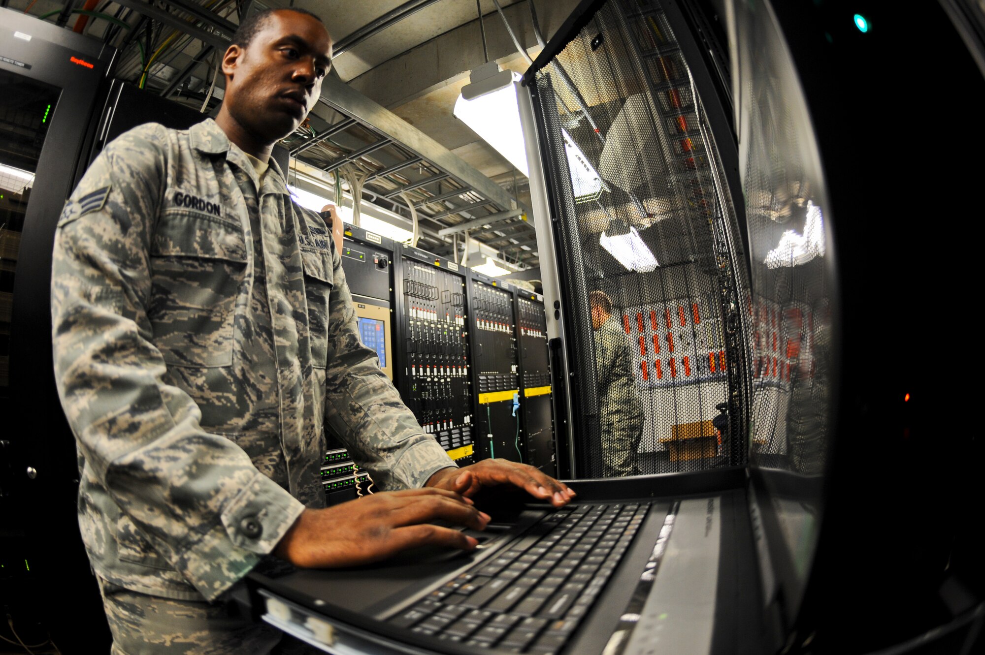 Senior Airman Darrian Gordon, 6th Communications Squadron airfield systems technician, configures Federal Aviation Administration mandated voice recording software at MacDill Air Force Base, Fla., Nov. 15, 2013. This software records all air traffic control communications, inbound and outbound. (U.S. Air Force photo by Airman 1st Class Ned T. Johnston/Released)