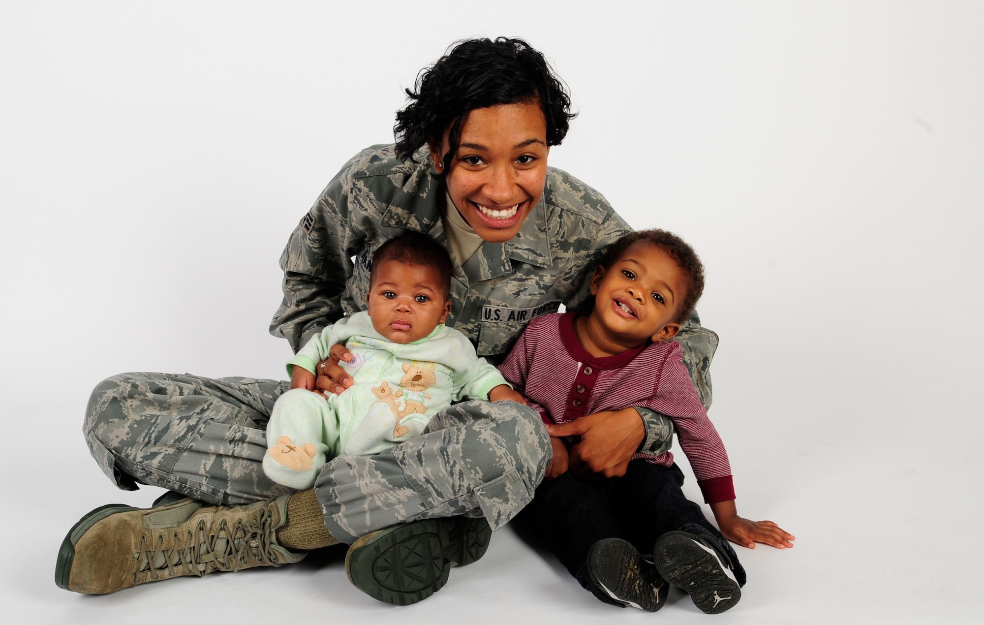 Senior Airman Jenay Randolph, 6th Air Mobility Wing Public Affairs photojournalist, poses for a picture with her children Nov. 25, 2013 at MacDill Air Force Base, Fla. Randolph is the mother of two under the age of two that finds the balance between single motherhood and active-duty Air Force.The son, Jaylen Brown, is 17 months and the daughter, Jordyn, is four months.(U.S. Air Force photo by Senior Airman Shandresha Mitchell/Released) 