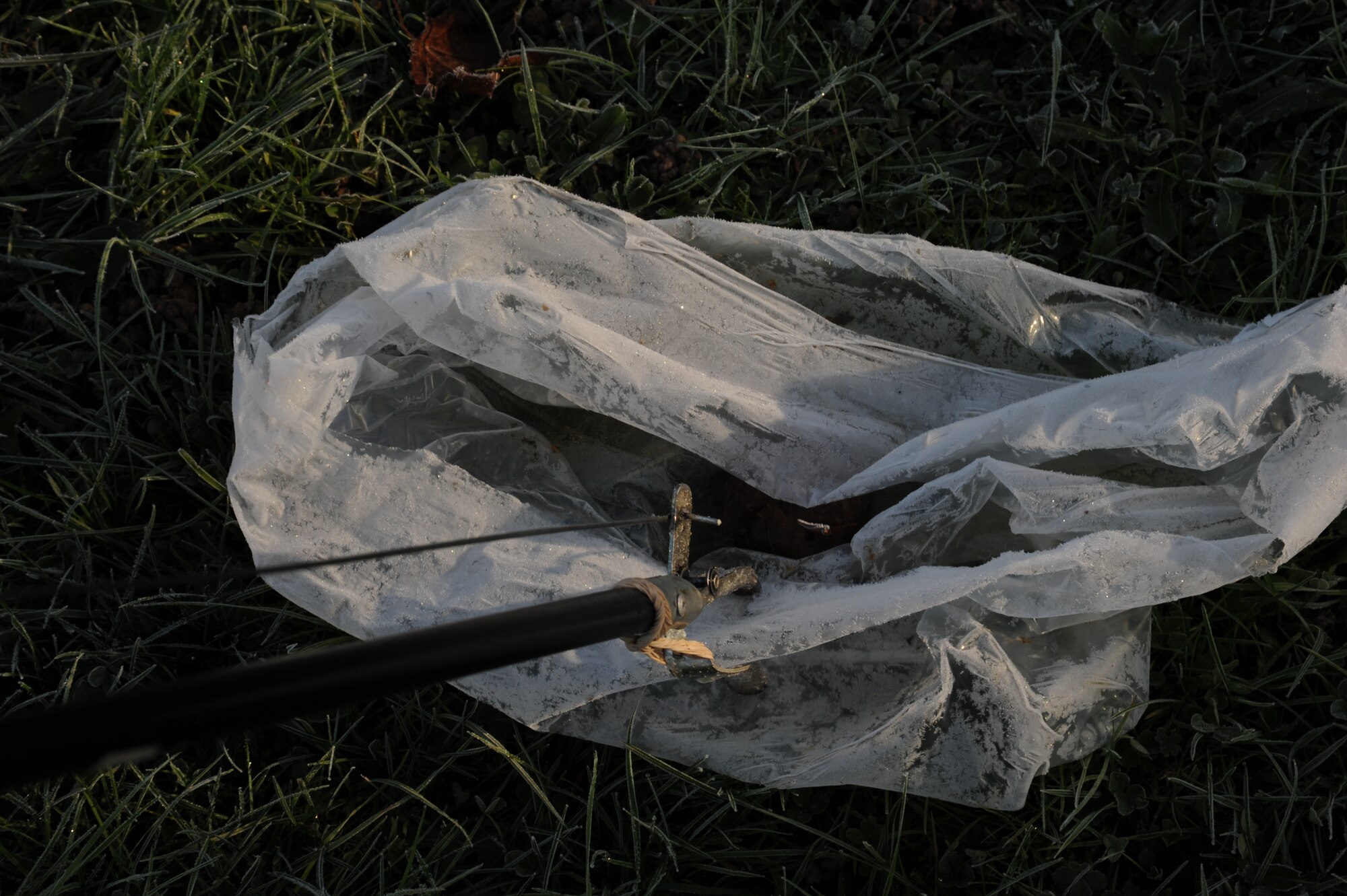 SPANGDAHLEM AIR BASE, Germany -- An Airman picks up a piece of trash along Perimeter Road Nov. 25, 2013. Eifel Pride is year-round, but Airmen do not always go out to pick up trash — it depends on the weather conditions. (U.S. Air Force photo by Airman 1st Class Dylan Nuckolls/Released)