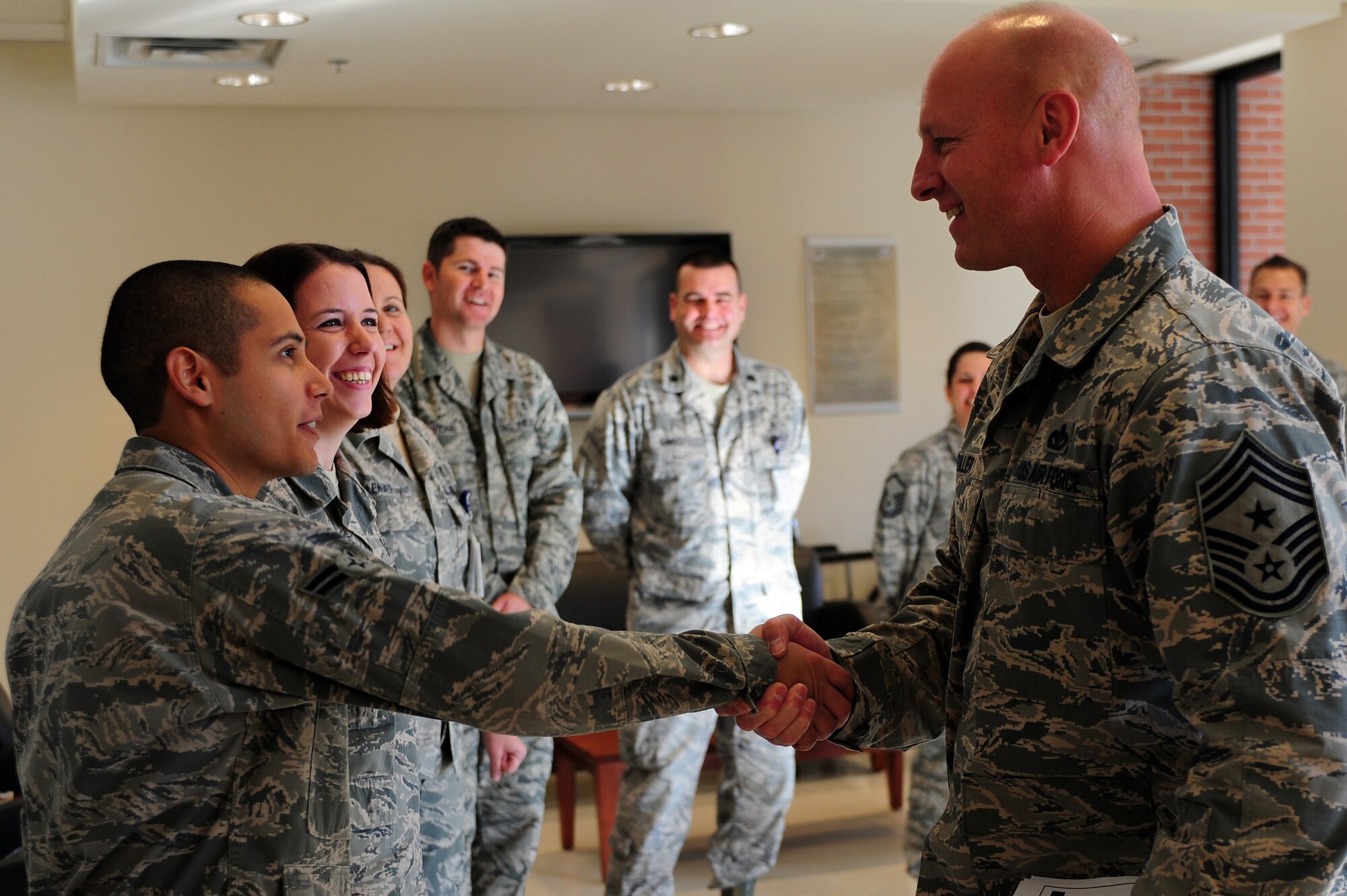 U.S. Air Force Chief Master Sgt. Scott Fuller, Ninth Air Force command chief, is greeted by Airman 1st Class David Callejas, 4th Aerospace Medicine Squadron public health technician, during a visit to Seymour Johnson Air Force Base, N.C., Nov. 21, 2013. This was Fuller’s first visit to the 4th Fighter Wing as Ninth Air Force command chief. (U.S. Air Force photo by Airman 1st Class John Nieves Camacho)