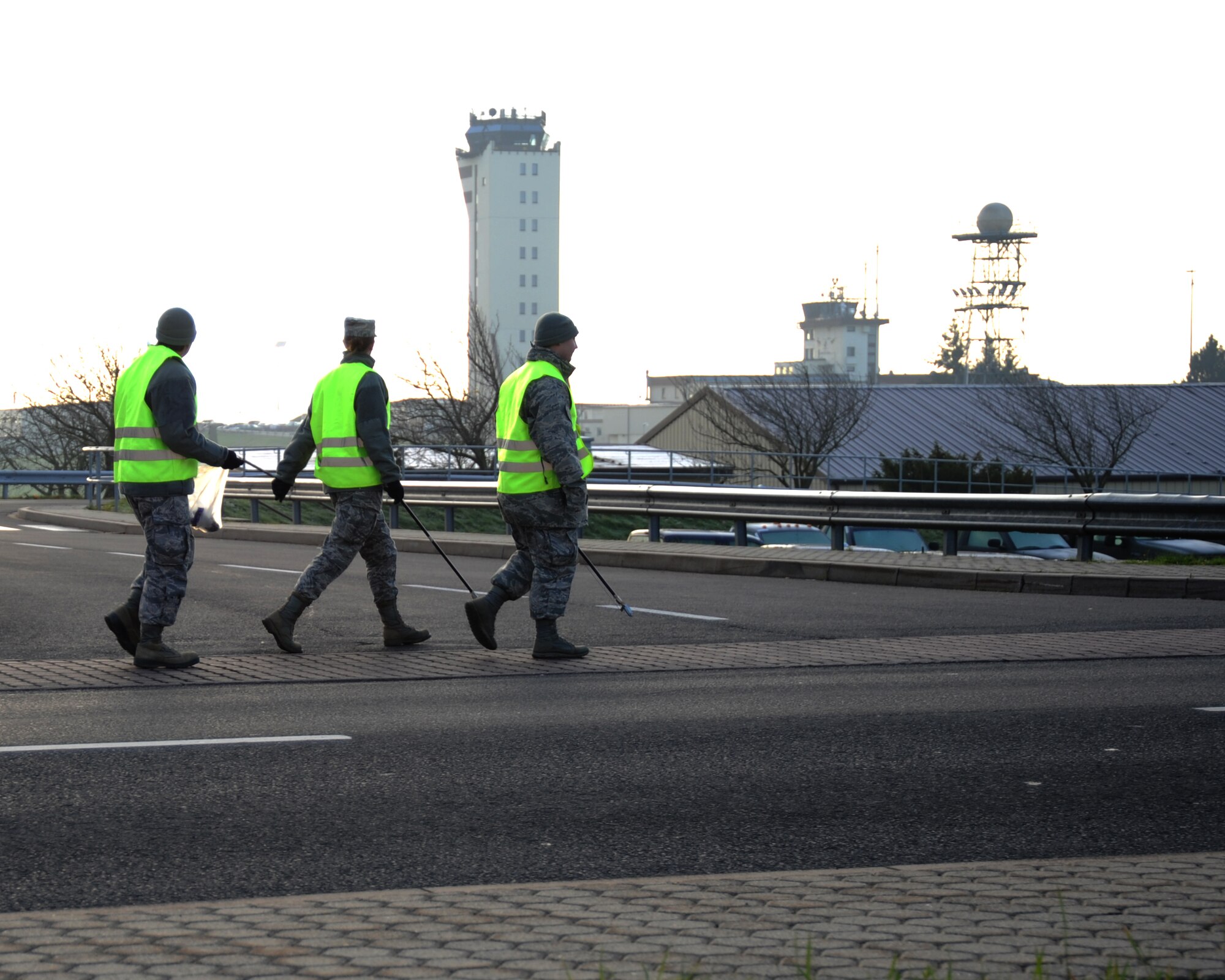 SPANGDAHLEM AIR BASE, Germany -- Airmen look for trash along Arnold Boulevard during a morning trash route Nov. 25, 2013. Eifel Pride is a two-week course where first-term Airmen keep the base clean while settling in to their first duty station. (U.S. Air Force photo by Airman 1st Class Dylan Nuckolls/Released)