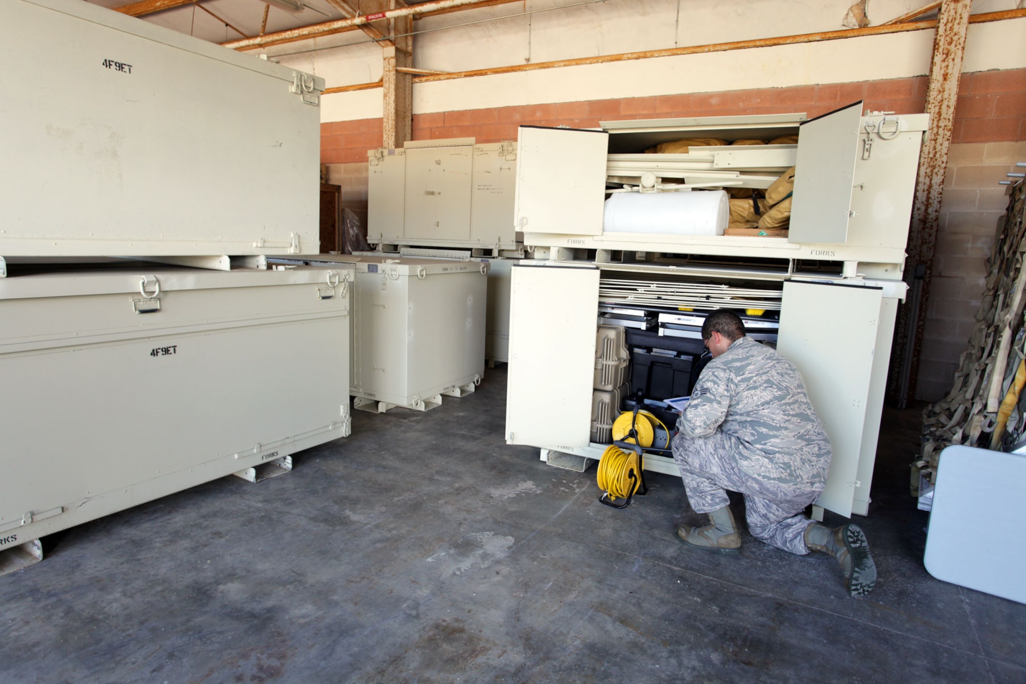HURLBURT FEILD, Fla. - Senior Airman Joshua Sherls, emergency management journeyman with the 1st Special Operations Civil Engineer Squadron here, checks the inventory of an emergency management unit type code, or UTC. Equipment experts at the Air Force Civil Engineer Center want to reduce the number of Air Force civil engineer UTCs that must be stored and maintained for contingency operations. This reduction would remove approximately $27 million in current equipment shortfalls and release $19 million in assets to help fill deficits. (U.S. Air Force photo/Eddie Green)