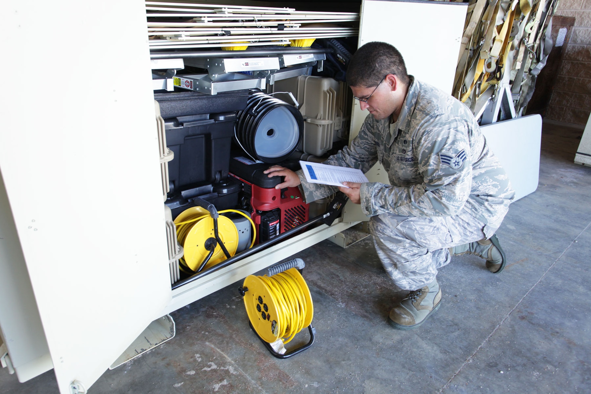 HURLBURT FEILD, Fla. - Senior Airman Joshua Sherls, an emergency management journeyman with the 1st Special Operations Civil Engineer Squadron here, checks the inventory of an emergency management unit type code, or UTC. UTCs are sets of tools, equipment or supplies assembled and packaged for deployment. Equipment experts at the Air Force Civil Engineer Center are looking at ways to reduce the number of Air Force civil engineer UTCs that must be stored and maintained for contingency operations. (U.S. Air Force photo/Eddie Green)