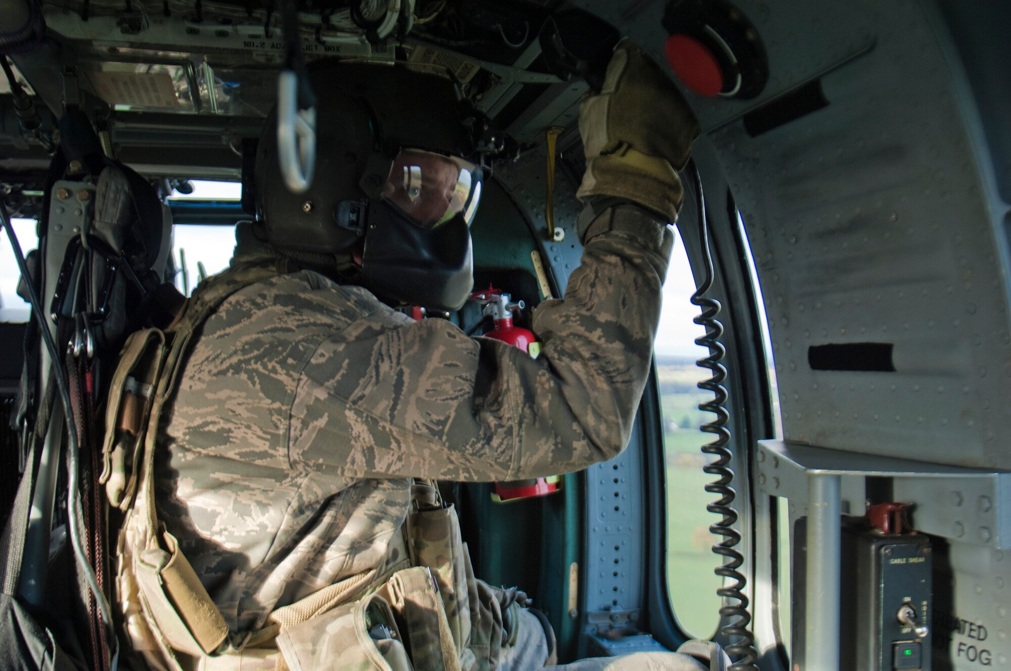 Tech. Sgt. Dale Mathews, 56th Rescue Squadron special mission aviator, peers out the window of an HH-60G Pave Hawk helicopter as it flies to the Royal Air Force Spadeadam Electronic Warfare Test Range, England, Nov. 21, 2013. The 56th RQS honed their skills engaging ground threats during an exercise Nov. 18-22. They were supported and kept in the air by the 748th Aircraft Maintenance Squadron. (U.S. Air Force photo by 2nd Lt. Keenan Kunst/Released)