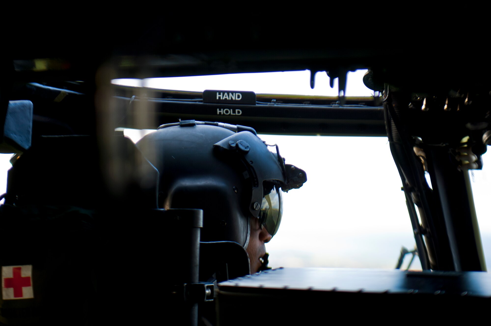 First Lt. Ryan Martelly, 56th Rescue Squadron pilot, communicates weather observations to the other pilot in the HH-60G Pave Hawk helicopter Nov. 21, 2013, over northern England, while en route to the Royal Air Force Spadeadam Electronic Warfare Test Range. Pilots from the 56th RQS rehearsed engagement of air defenses and ground threats as part of an exercise Nov. 18- 22.  (U.S. Air Force photo by 2nd Lt. Keenan Kunst/Released)