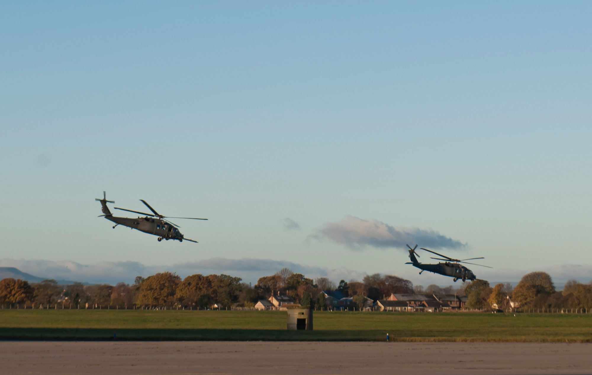 Two HH-60G Pave Hawk helicopters from the 48th Fighter Wing’s 56th Rescue Squadron take off from Royal Air Force Leeming, Engalnd, Nov. 19, 2013. The helicopters flew out of RAF Leeming for electronic warfare training over the RAF Spadeadam test range, where they had the opportunity to hone their skills engaging real ground threats and air defenses.  (U.S. Air Force photo by 2nd Lt. Keenan Kunst)