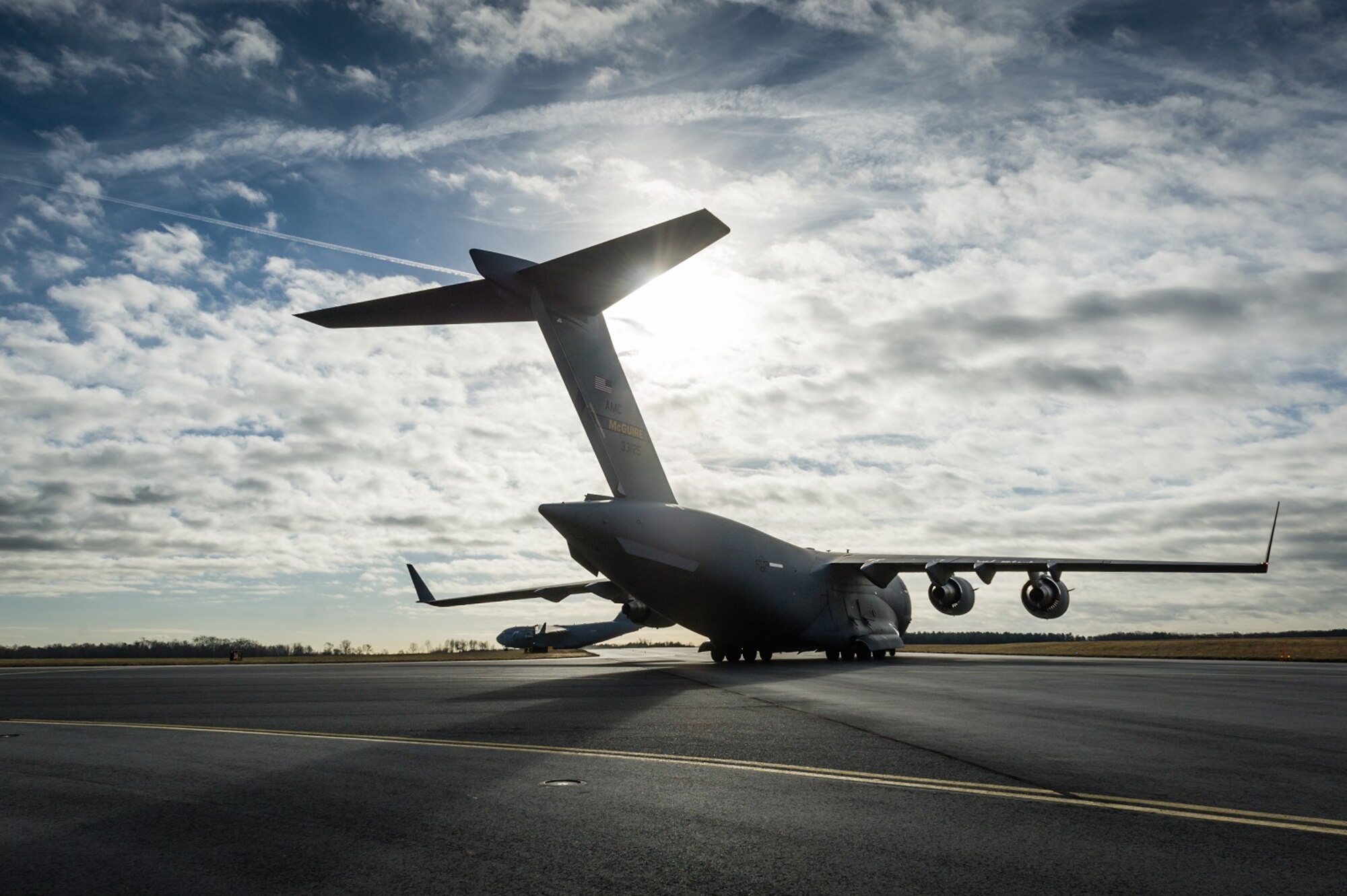 An "Elephant Walk," comprising 12 KC-10 Extenders and six C-17 Globemaster IIIs from the 305th Air Mobility Wing, was held Nov. 21, 2013, as part of a training exercise at Joint Base McGuire-Dix-Lakehurst, N.J.  The exercise enabled aircrew, maintenance, command post and operational support personnel to test their ability to launch a mass amount of aircraft in support of real-world operations. An Elephant Walk is a nose-to-tail taxi formation. (u.S. Air Force photo by Russ Meseroll/Released)