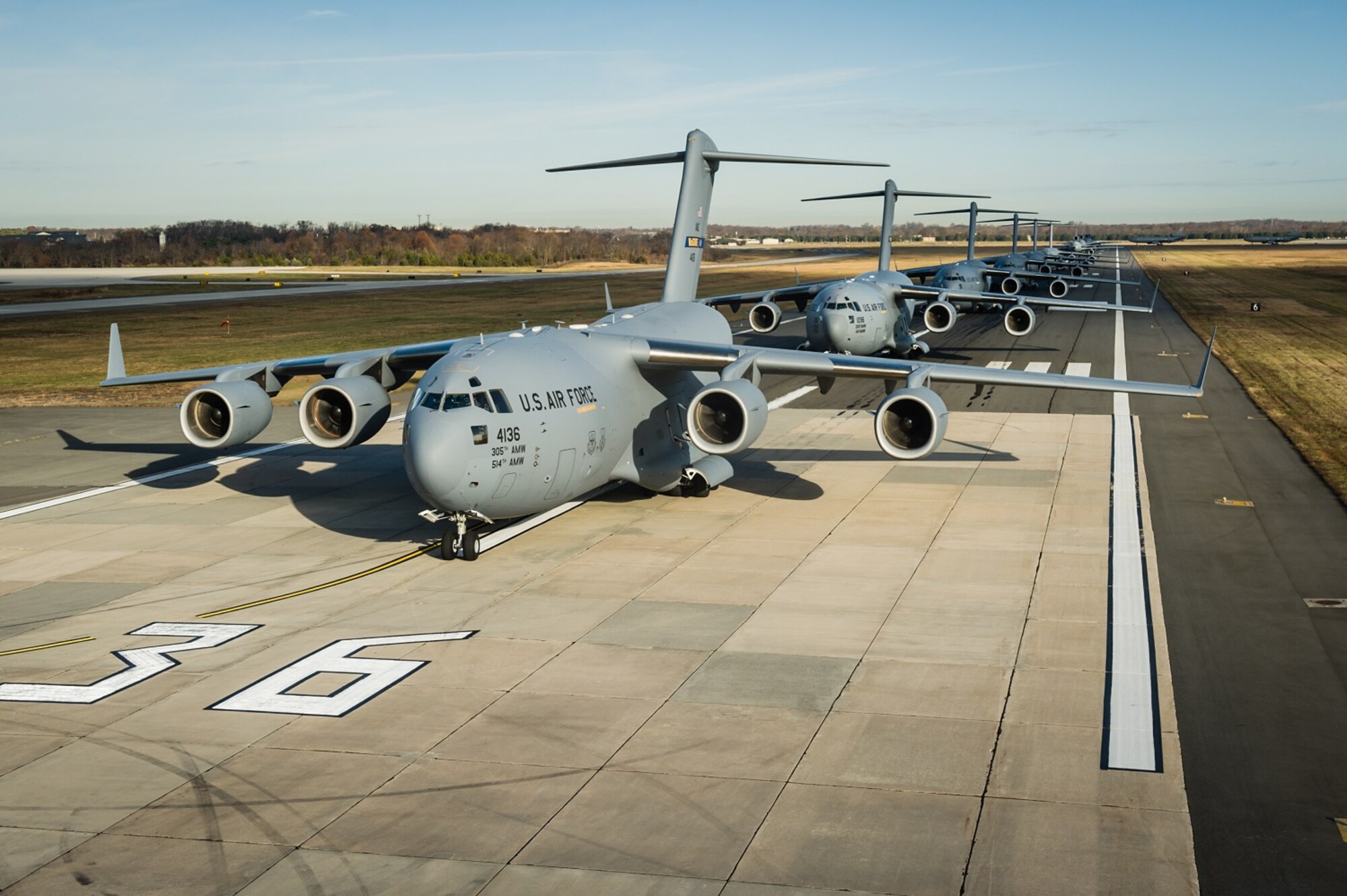 An "Elephant Walk," comprising 12 KC-10 Extenders and six C-17 Globemaster IIIs from the 305th Air Mobility Wing, was held Nov. 21, 2013, as part of a training exercise at Joint Base McGuire-Dix-Lakehurst, N.J.  The exercise enabled aircrew, maintenance, command post and operational support personnel to test their ability to launch a mass amount of aircraft in support of real-world operations. An Elephant Walk is a nose-to-tail taxi formation. (u.S. Air Force photo by Russ Meseroll/Released)