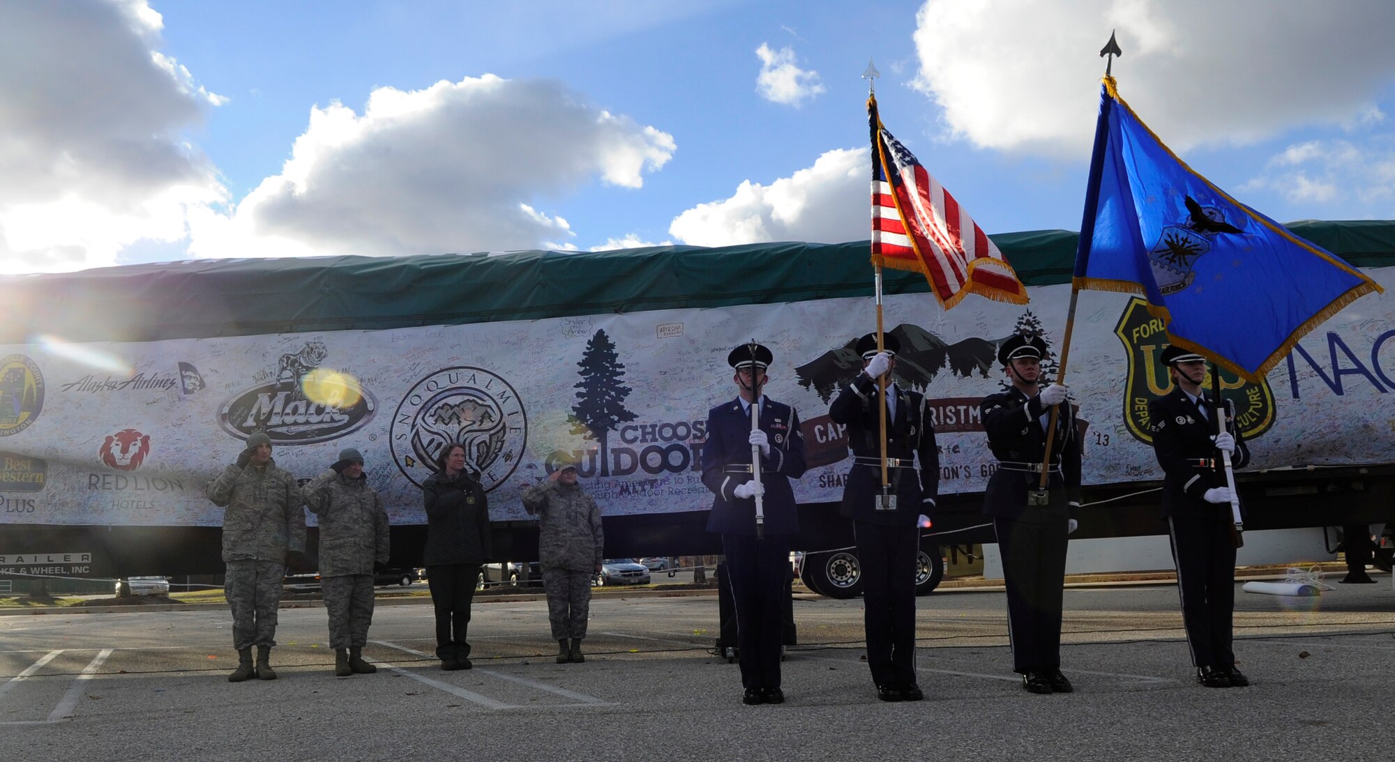 Joint Base Andrews Honor Guard presents the colors during a celebration to welcome the Capitol Christmas tree to Joint Base Andrews, Md., Nov. 24, 2013. The 88-foot tall tree traveled more than 5,000 miles across the country from Washington and made its final stop here before its decorated and put up for display at the U.S. Capitol Building’s west lawn. The Capitol Christmas Tree has been a tradition at the U.S. Capitol since 1964. The tree will be lit from night fall until 11 p.m. each evening through January 1, 2014.  (U.S. Air Force photo/Airman 1st Class Nesha Humes)