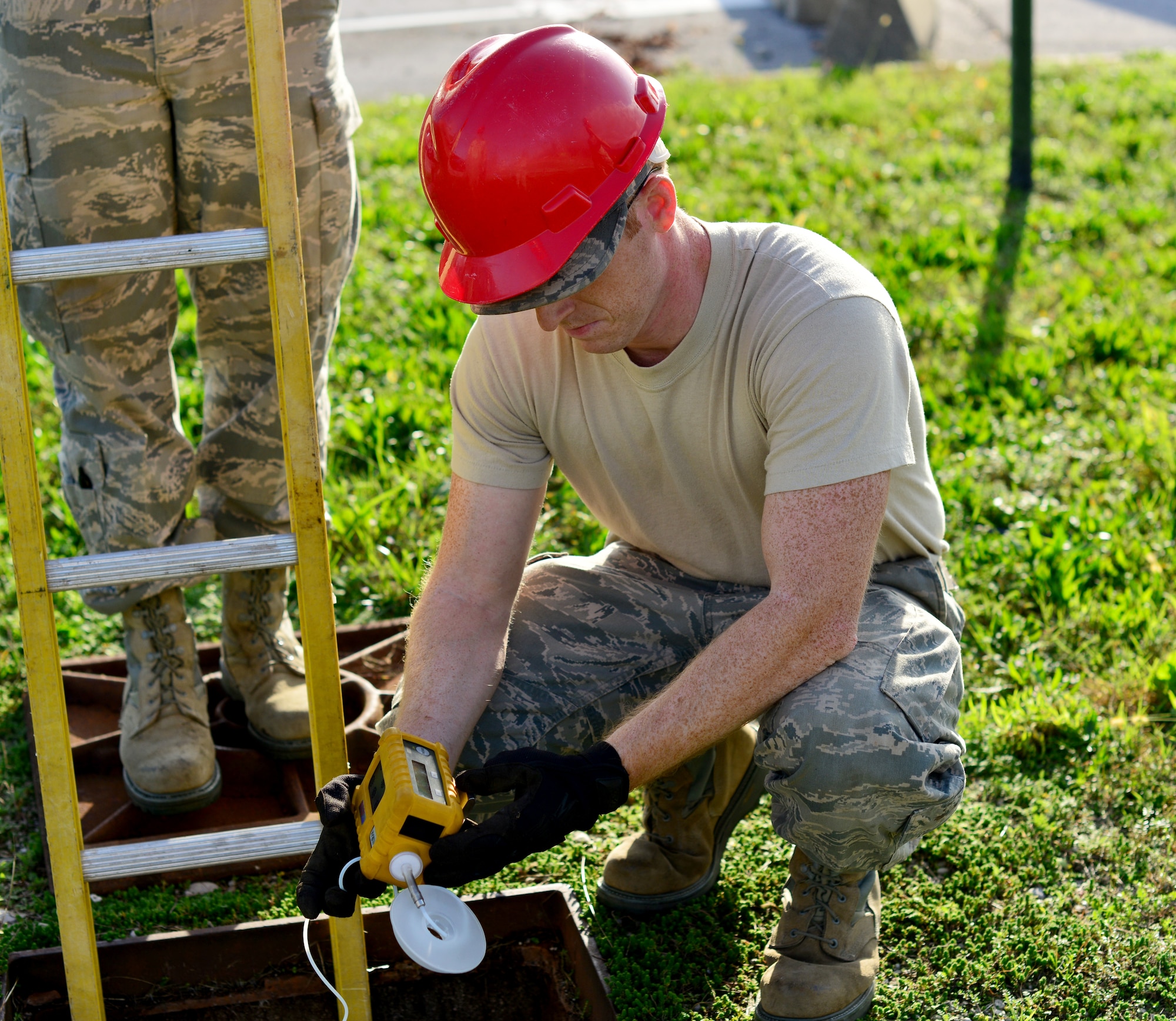 Senior Airman Kyle Ragan, 31st Communications Squadron cable systems journeyman, tests for combustible gas using a hazardous waste detector, Nov. 13, at Aviano Air Base, Italy. “Cable Dawgs” maintain more than 20,000 miles of cable fiber throughout the base connecting Team Aviano to 14 geographically- separated units. (U.S. Air Force photo/Senior Airman Briana Jones)