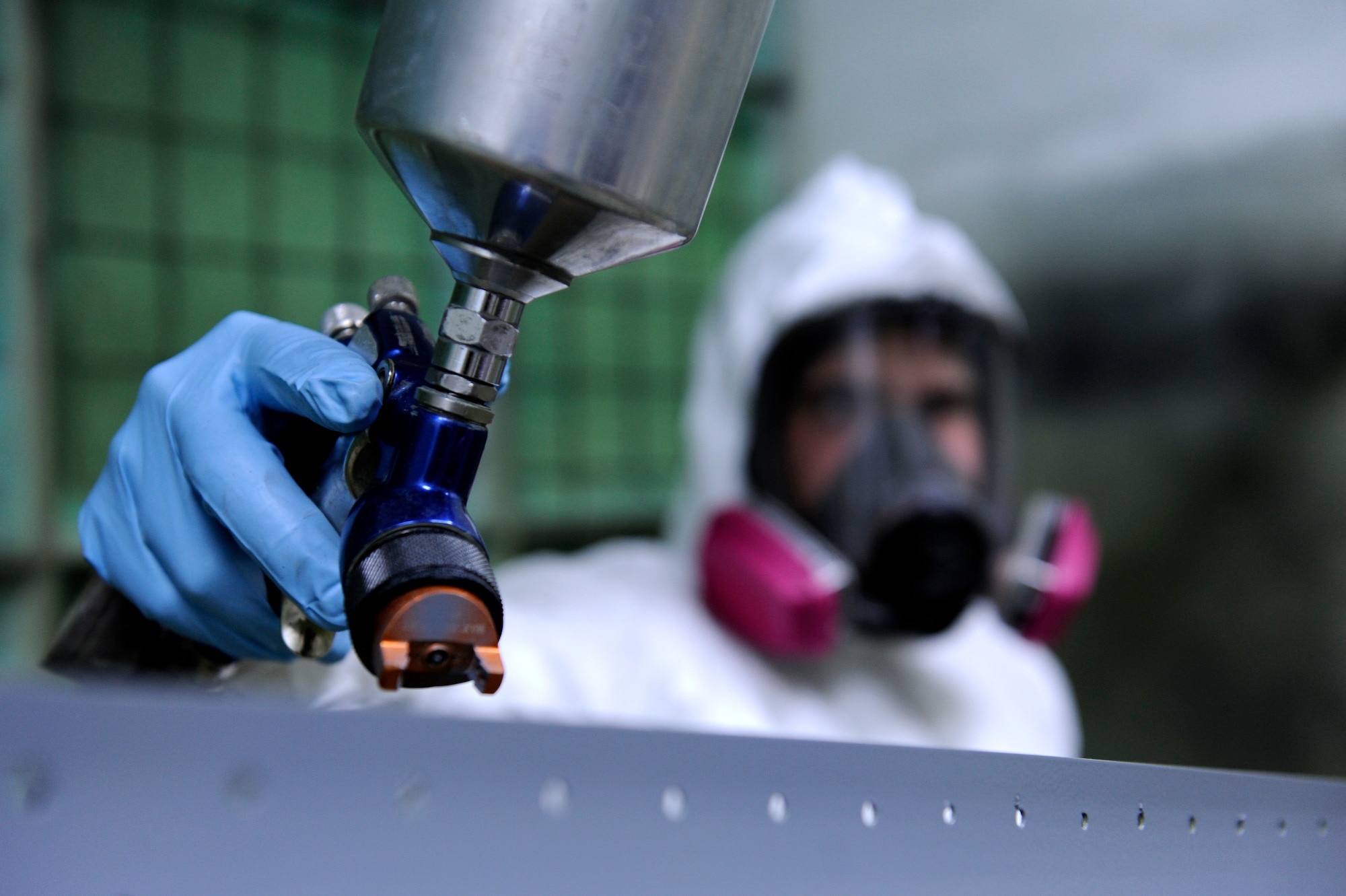 U.S. Air Force Staff Sgt. Jordan Smith, 18th Equipment Maintenance Squadron aircraft structural maintenance technician who hails from Lawton, Mich., spray paints aircraft parts on Kadena Air Base, Japan, Nov. 21, 2013. As aircraft parts bend, break or corrode over time, the Airmen from the Aircraft Structural Maintenance flight step in to repair or replace the faulty equipment -- often saving the Air Force thousands of dollars in the process. (U.S. Air Force photo by Senior Airman Maeson L. Elleman)