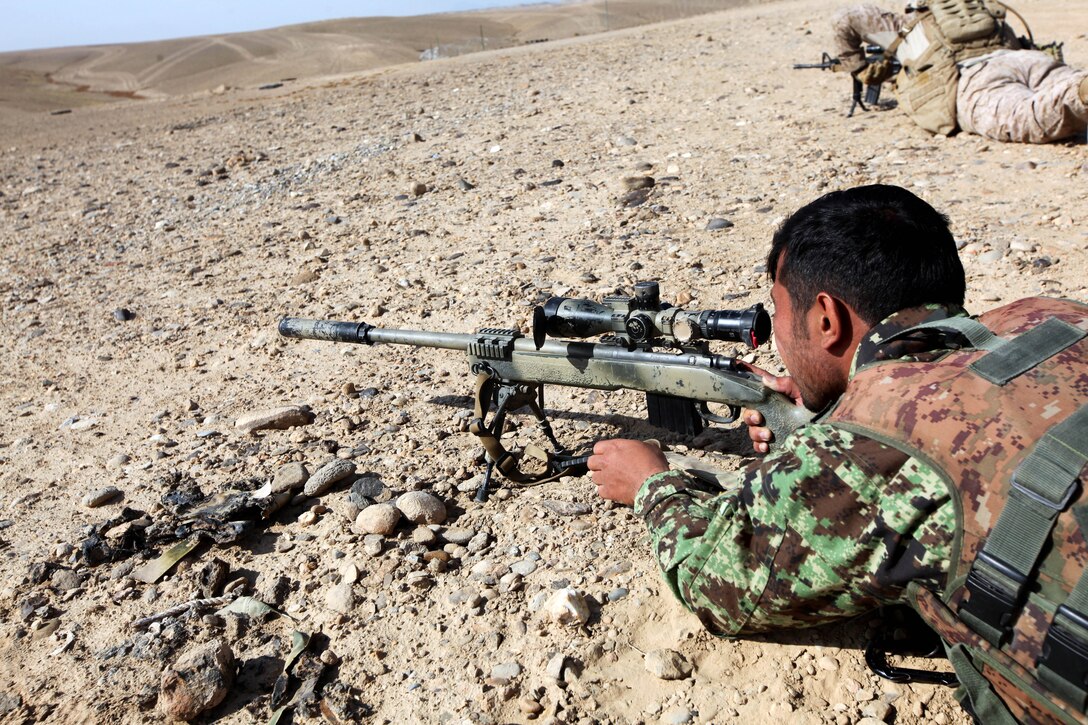 An Afghan soldier fires an M40A5 sniper rifle at a range on Forward Operating Base Shukvani in Afghanistan's Helmand province, Nov. 18, 2013.
