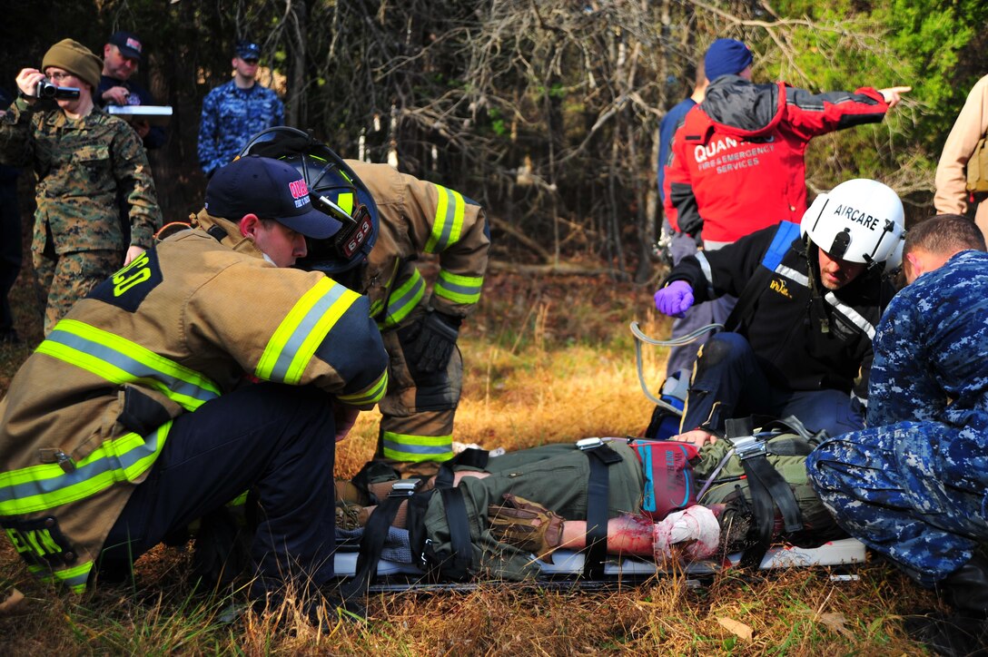 Firemen, Marines, corpsmen and Protected Health Information Air Medical members prepare a wounded role player for aerial transportation to a hospital, during a training exercise at Camp Goettge aboard Marine Corps Base Quantico on Nov. 19, 2013. 