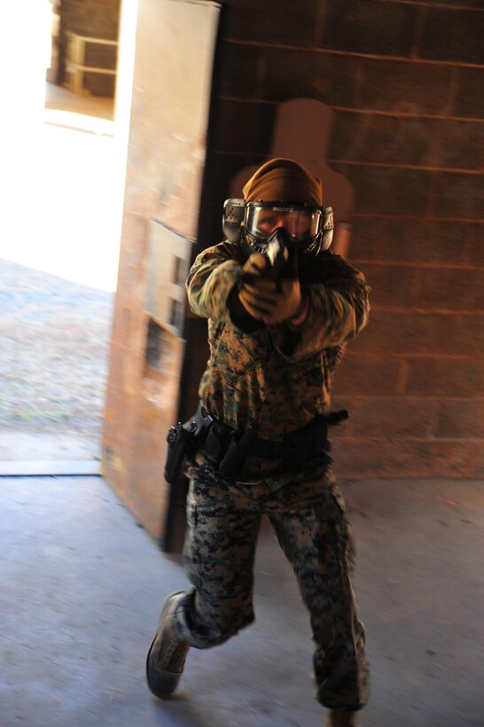 Marines and police officers with Security Battalion conduct their final active shooter training for 2013 at combat town aboard Marine Corps Base Quantico on Nov. 20, 2013. The exercise was conducted with the help of simulation rounds, stationary and moving targets. The moving targets were volunteers from Combat Camera, this proved a more realistic scenario for the shooters.