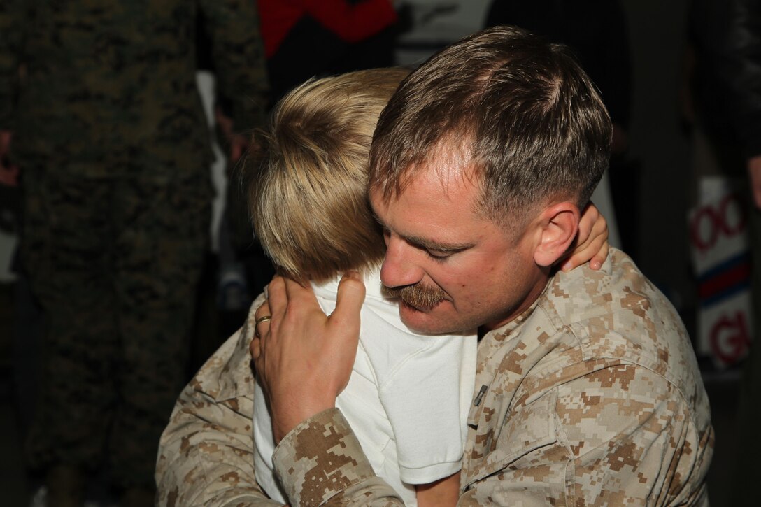 Capt. Caleb Joiner, unmanned aerial vehicle mission commander, Unmanned Aerial Vehicle Squadron 1, is reunited with his son, Miles, 3, during the squadron's homecoming at the VMU-1 hangar Nov. 22, 2013.


