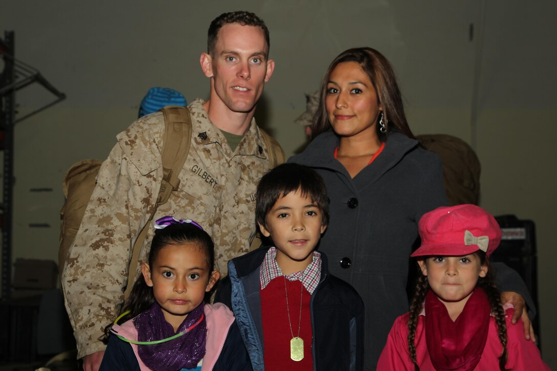 Sgt. Joshua Gilbert, imagery analyst specialist, Unmanned Aerial Vehicle Squadron 1, is reunited with his wife, Lisa, and children, Jayden, 9, Makayla, 8, and Mackenzie, 6, during the squadron's homecoming at the VMU-1 hangar Nov. 22, 2013.


