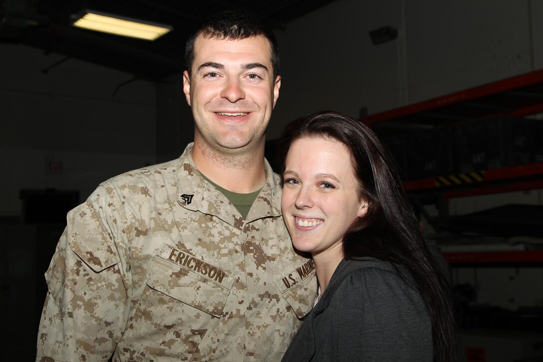Cpl. Dillon Erickson, field radio operator, Unmanned Aerial Vehicle Squadron 1, is reunited with his girlfriend, Gail Bolander, during the squadron's homecoming at the VMU-1 hangar Nov. 22, 2013.