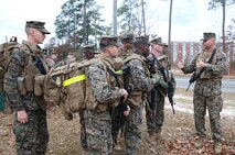First Sgt. Damian P. Wright (right), the first sergeant of Ragnarok Company, 2nd Supply Battalion, 2nd Marine Logistics Group, briefs the company’s road guards prior to a five-mile hike aboard Camp Lejeune, N.C., Nov. 26, 2013. The hike was the first of several conditioning movements to prepare the Marines and sailors with the company for an upcoming mission in Norway. (U.S. Marine Corps photo by Lance Cpl. Sullivan Laramie)