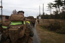 Service members with Ragnarok Company, 2nd Supply Battalion, 2nd Marine Logistics Group walk at route step during five-mile hike aboard Camp Lejeune, N.C., Nov. 26, 2013. The Marines and sailors carried assault packs with extra clothing and equipment, while wearing flak jackets, to build physical endurance in preparation for Exercise Cold Response 2014 in Norway. (U.S. Marine Corps photo by Lance Cpl. Sullivan Laramie)