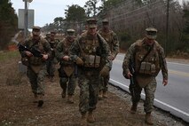 Lt. Col. Jesse A. Kemp (center), the commanding officer of 2nd Supply Battalion, 2nd Marine Logistics Group, and the command staff of Ragnarok Company, 2nd Supply Bn. lead the company on a five-mile hike aboard Camp Lejeune, N.C., Nov. 26, 2013. The hike provided physical conditioning as well as an opportunity to build camaraderie within the new unit. (U.S. Marine Corps photo by Lance Cpl. Sullivan Laramie)